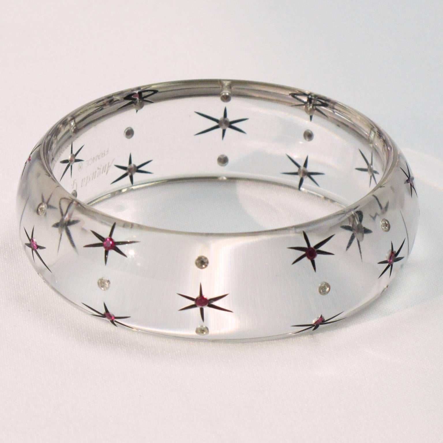 1960s chunky Lucite bracelet bangle by Augusta G., France. Featuring a crystal clear domed bangle shape with etched star design and compliment with clear and hot pink rhinestones. Engraved signature inside: 