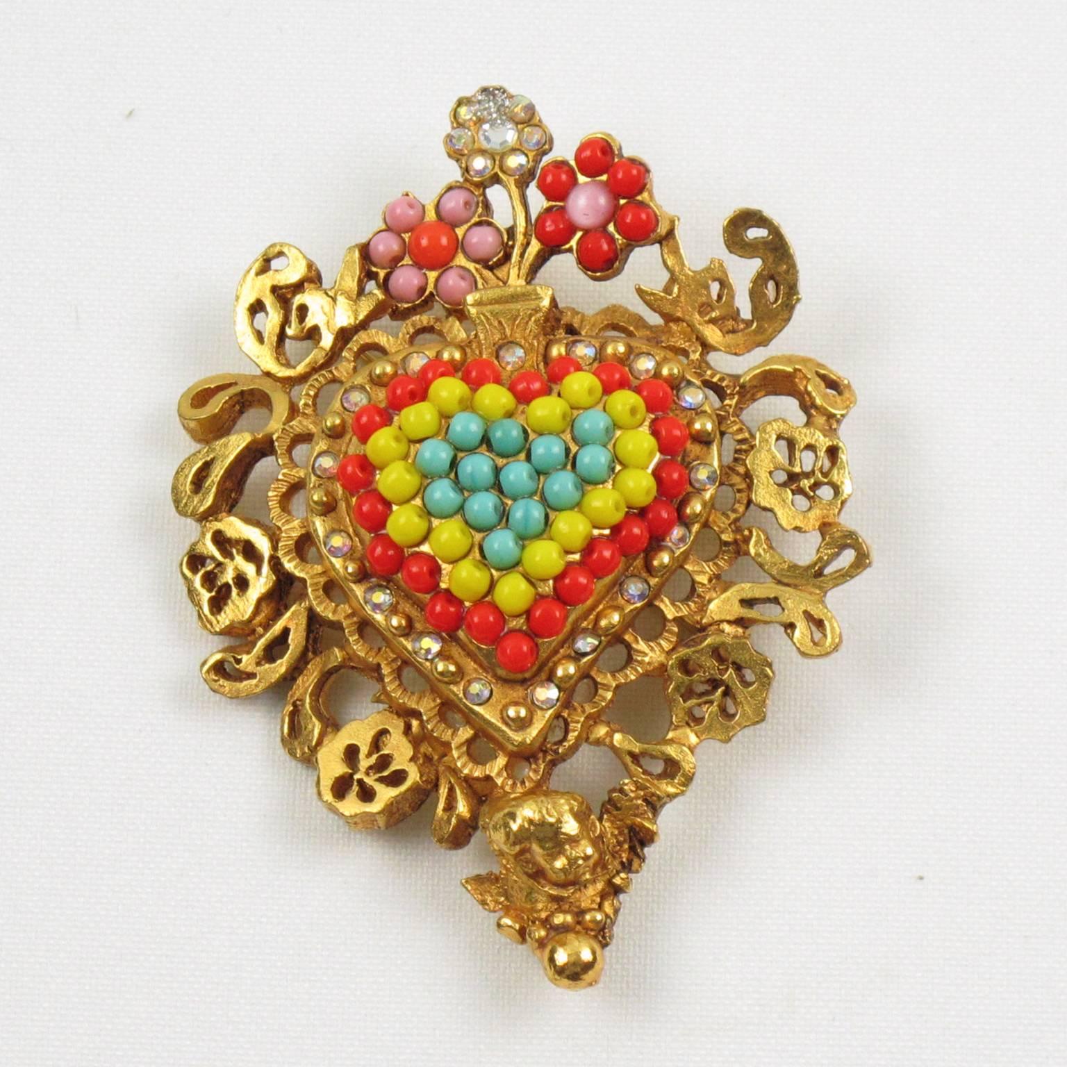 Impressive CHRISTIAN LACROIX Paris signed couture Pin Brooch. Fabulous gilt metal all carved and see thru shape, metal all textured featuring a large baroque inspired heart ornate with cherub face and topped colorful glass beads and aurora borealis