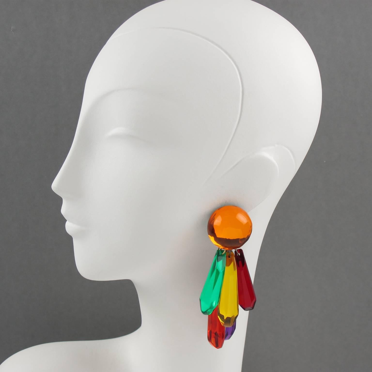 Vintage statement oversized dangling chandelier Lucite clip on earrings by Harriet Bauknight for Kaso. Huge dimensional shape with geometric dangling charms with mirror texture pattern. Assorted colors of electric orange, lime green, yellow, fire