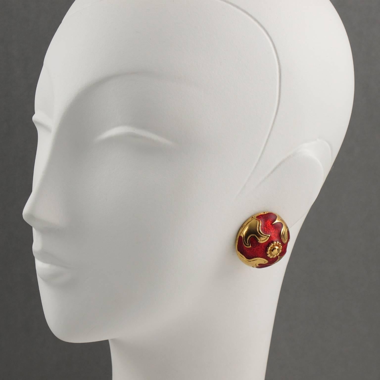 YVES SAINT LAURENT Paris signed clip on earrings. Baroque round domed shape, shinny gilt metal with texture ornate with bright red enamel. Signed at the back with YSL pierced logo on clip and engraved underside: "YSL logo". Excellent