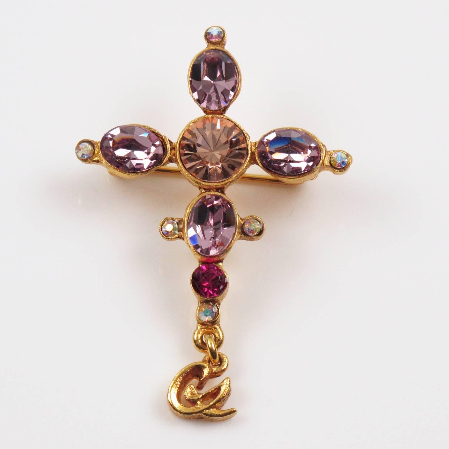 Lovely vintage Christian Lacroix Paris signed Pin Brooch. Jeweled cross shape with gilt metal all textured and ornate with pink and purple rhinestones. Little dangling 