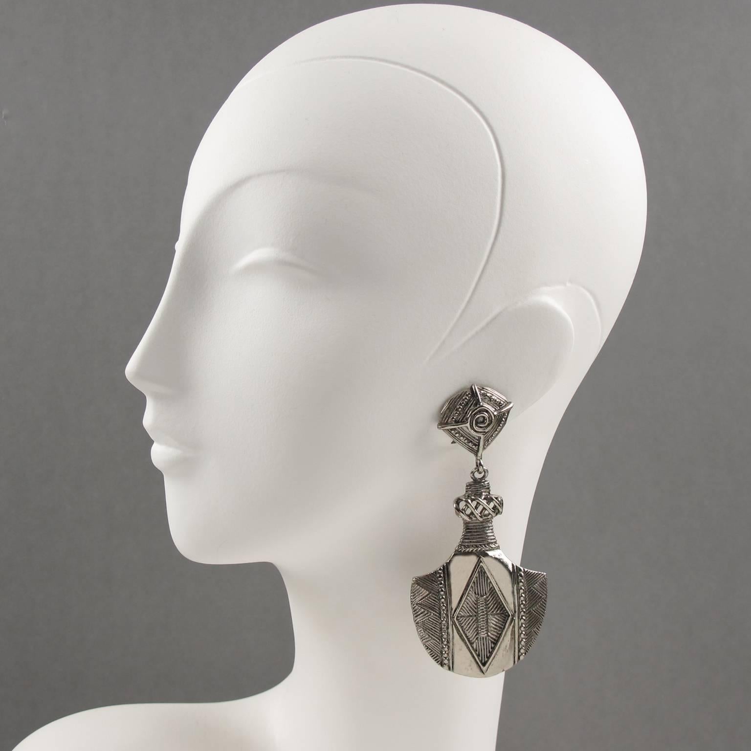 Vintage French designer JEAN LOUIS SCHERRER Paris signed clip on earrings. Rare silvered metal oversized dangling chandelier shape with African Tribal inspired carving. Signed underside with tag: 