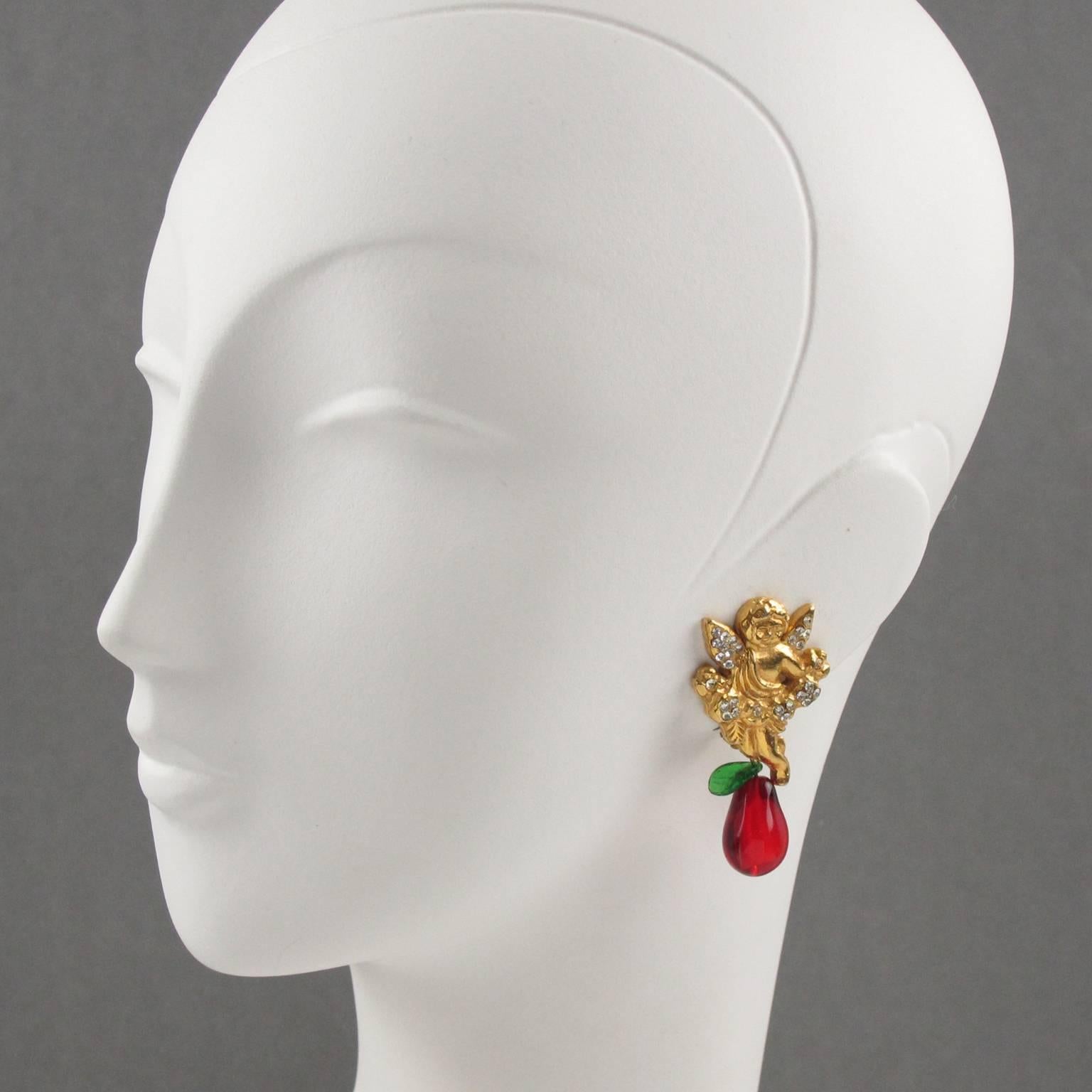 Lovely French fashion designer Sonia Rykiel Paris signed clip on earrings. Featuring gilt metal Cherub or Cupid ornate with clear rhinestones. Pear and leaf dangling charms in blown glass with red and green colors. Signed underside: Sonia Rykiel -