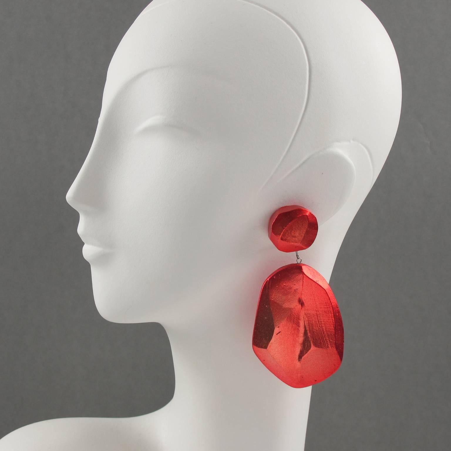 Sophisticated oversized clip on earrings, by Mary Oros, circa 1980s. Featuring large organic feel dangling shape in cast resin with incredible red/pink metallic paint color. Signed at the back with engraved 