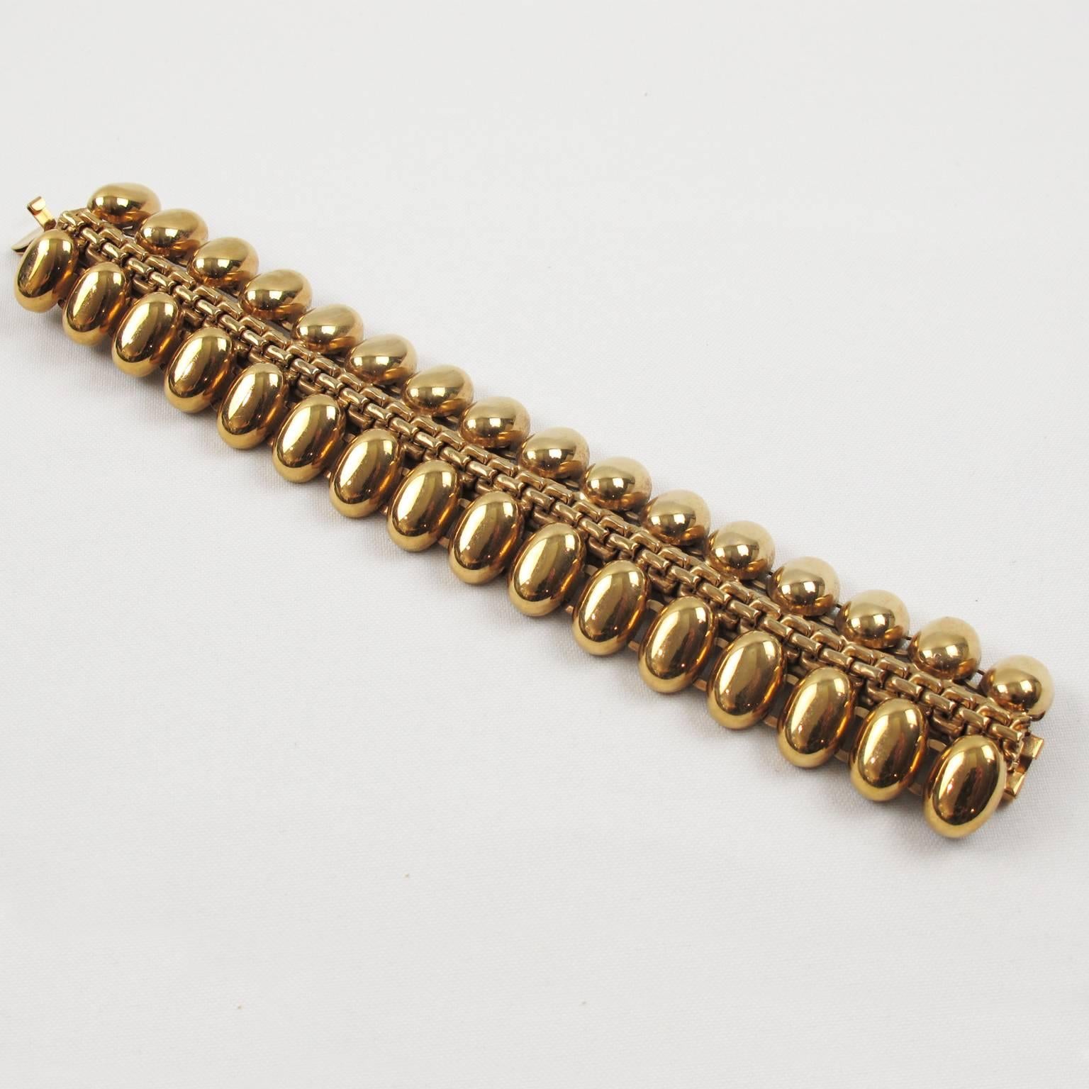 1940s French retro Tank bracelet of oversized gilt metal links. Distinct Machine Age design, the high polish of the gilded metal gives this piece of jewelry a true 3 dimensional look. Architectural heavy geometric shape is typical of the machine