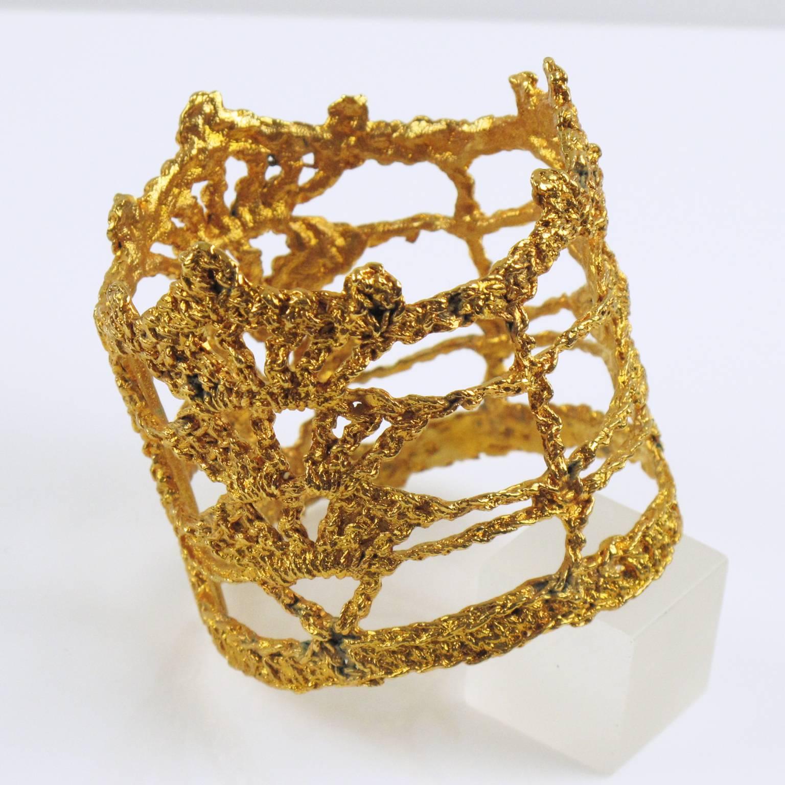 Rare 1990s Christian Lacroix Paris signed bangle bracelet. Unusual oversized wide bracelet with knitting design in gold plate finish. This is real knitting dipped into gold plating bath. Spectacular shape. Signed in the inside with Lacroix ovoid