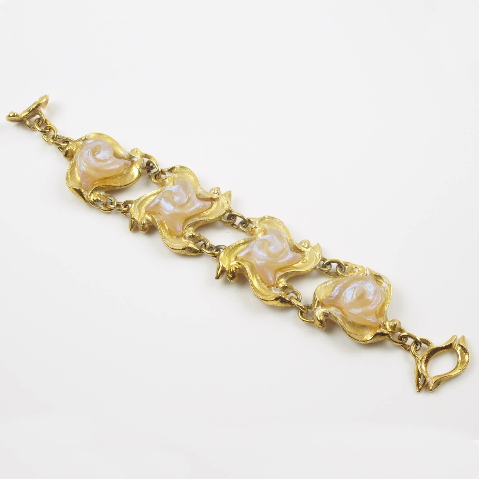 Vintage 1980s French designer L'Or Du Soir Paris signed link bracelet. Byzantine inspired design with gilt metal links topped with frosted champagne floral resin cabochon with iridescent overtone. High end quality with gorgeous detailed design with