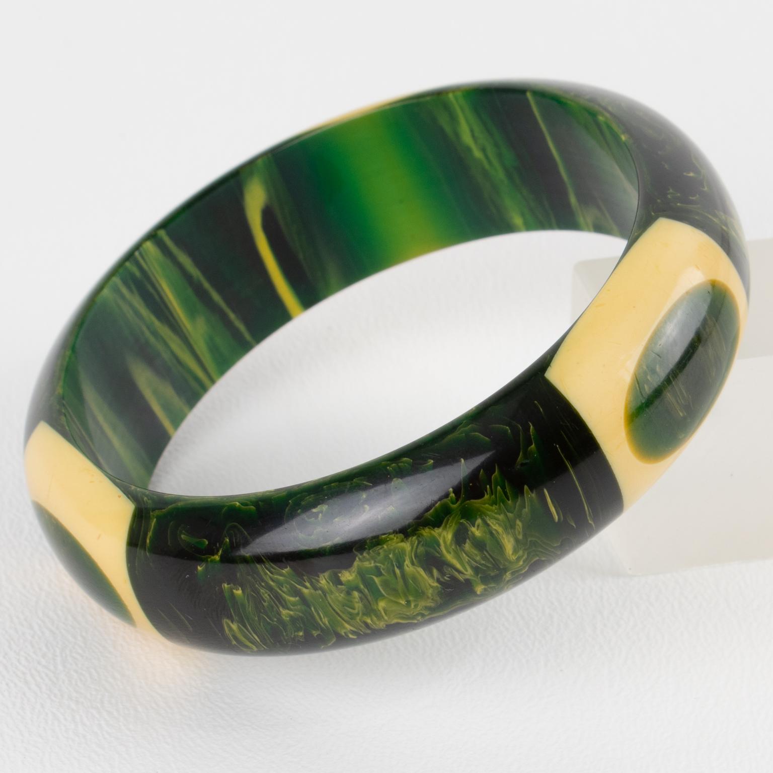 Ce remarquable bracelet à points allongés en bakélite Belle Kogan est un must dans une collection de bakélite. Les points sont entourés de bananes jaunes dans un marbre vert et apparaissent trois fois sur le bracelet. Le bracelet a une forme bombée