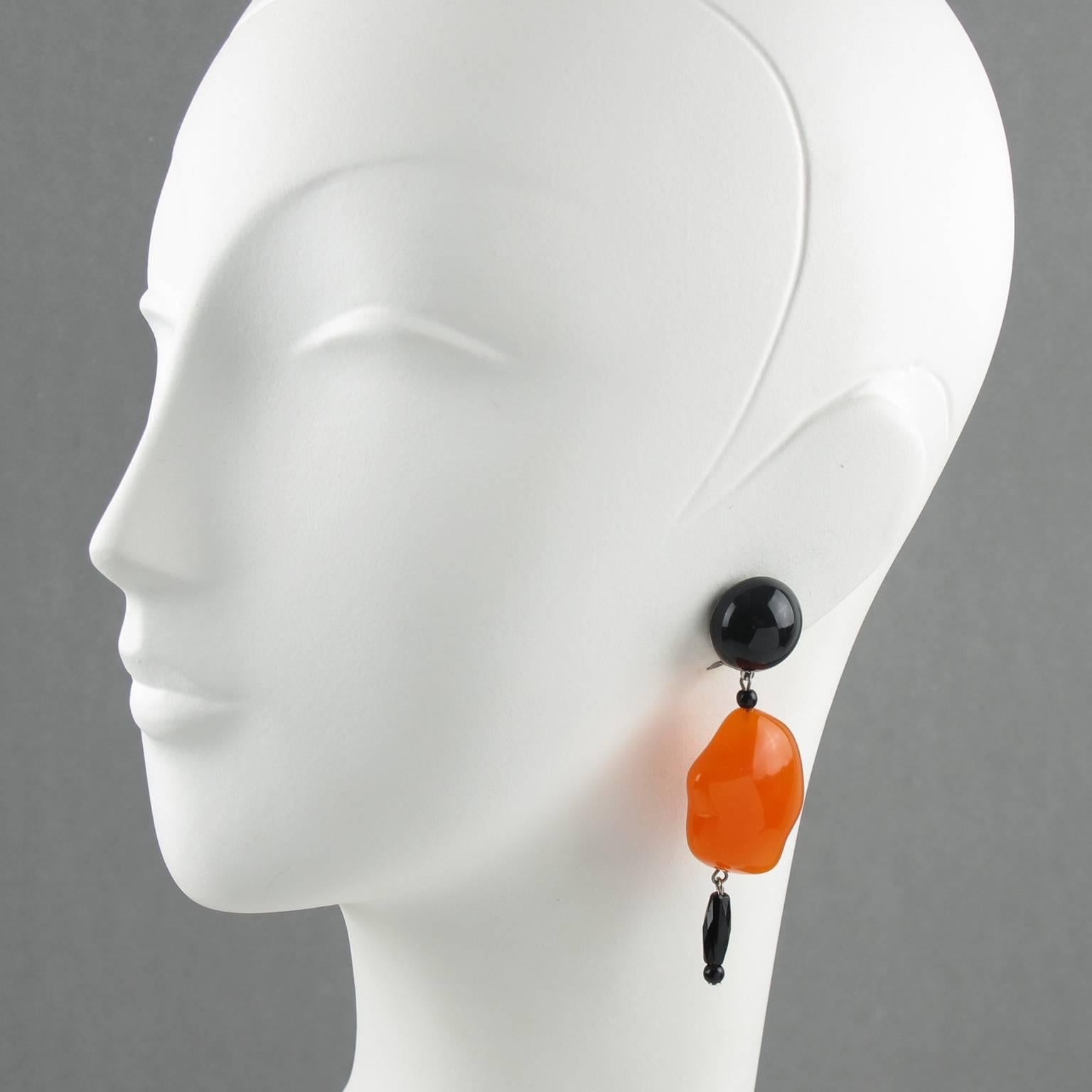 Elegant Angela Caputi, made in Italy resin clip on earrings. Dangling shape with black color contrasted with translucent carrot orange resin pebble bead. Her matching of colors is always extremely classy, perfect for casual as well as fancy