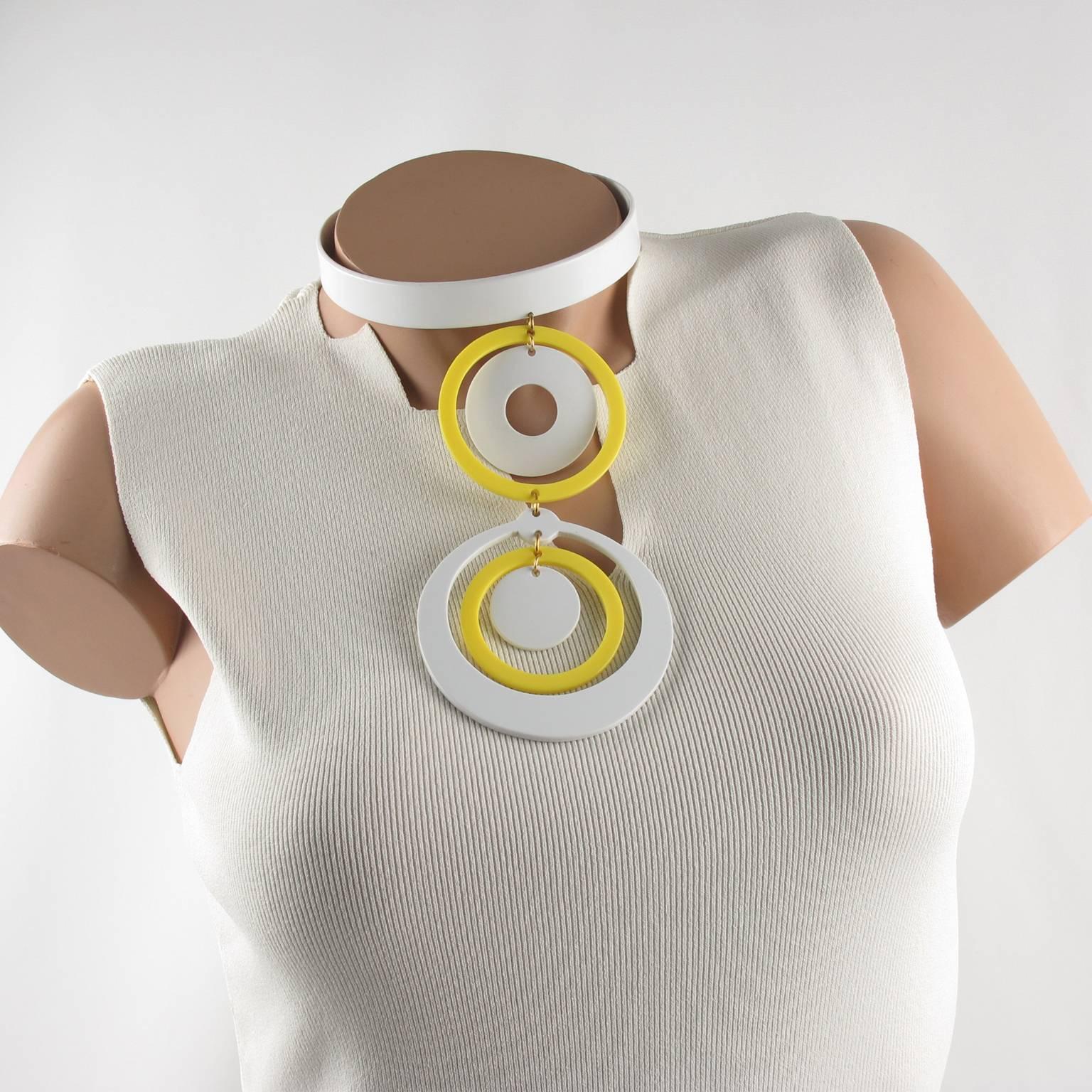 Stunning French designer Andre Courreges geometric-shaped, mod yellow and white dog collar necklace. Space age choker features different sized linked cut-out plastic or lucite disks. No visible marking. 
Measurements: necklace drop 6.50 in. long