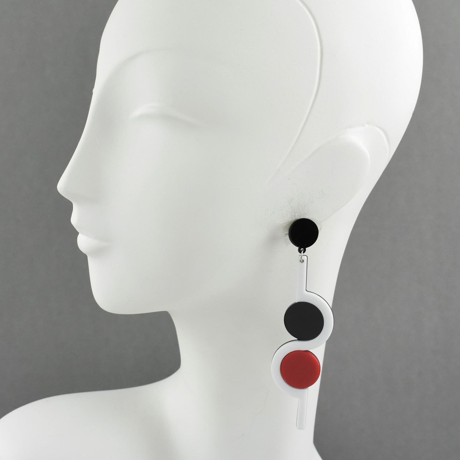 Stunning designer studio extra long Lucite earrings for pierced ears. Featuring minimalist dangling drop design with geometric shape. Classy assorted colors of black, red and white. No visible signature. 
Measurements: 4.13 in. long (10.5 cm) x 1.07