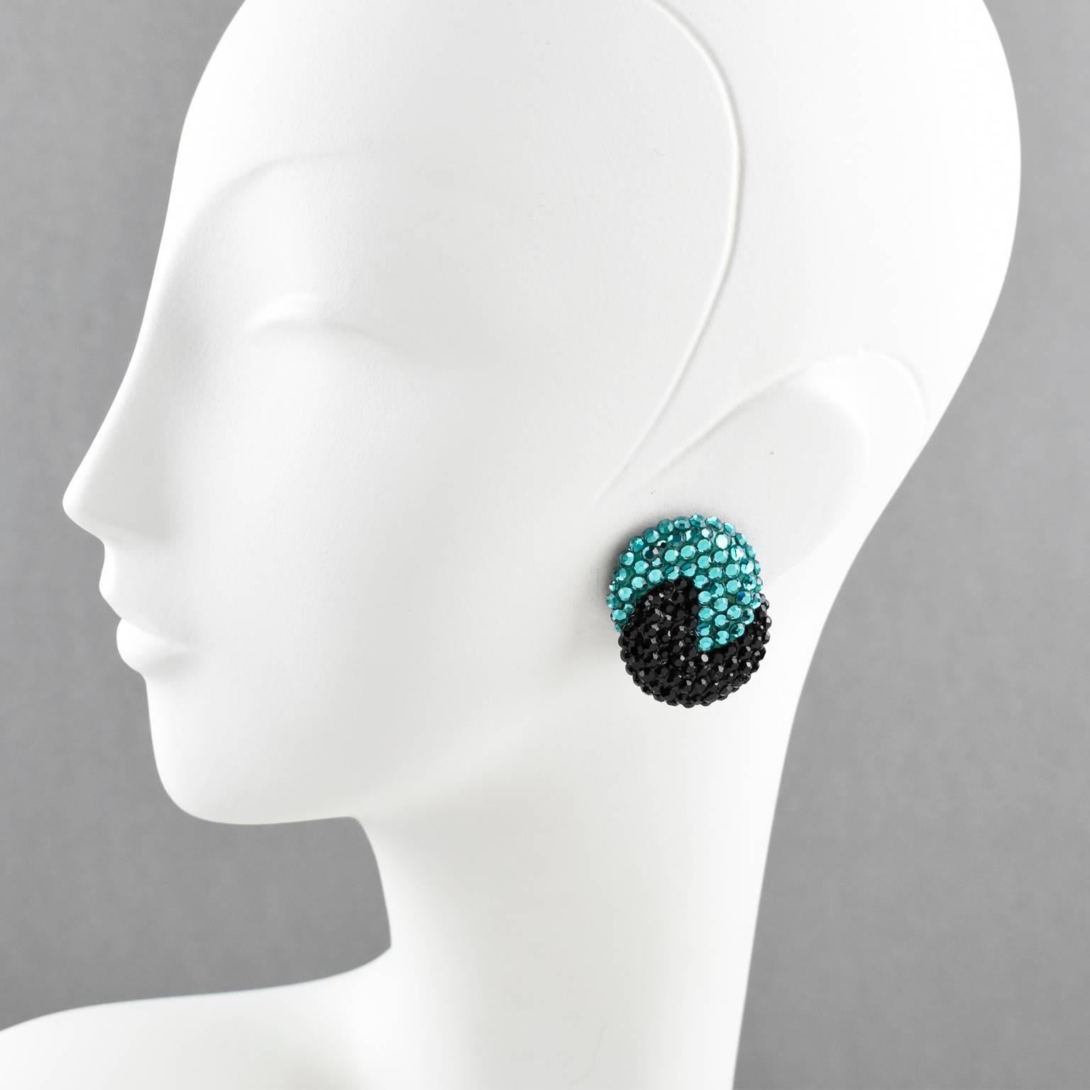 Elegant statement clip-on earrings designed by Richard Kerr in the 1980s. They are made up of his signature pave rhinestones. Featuring Yin and Yang swirl shape all covered with colorful crystal rhinestones on black resin background frame. Vivid