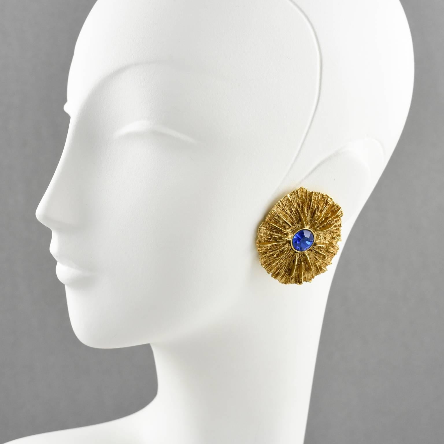 Stunning Yves Saint Laurent YSL Paris huge clip-on earrings. Elegant gilt metal floral shape, metal all textured with dimensional carved design, compliment with cobalt blue crystal rhinestone. Signed at the back 'YSL Made in France'. 
Measurements: