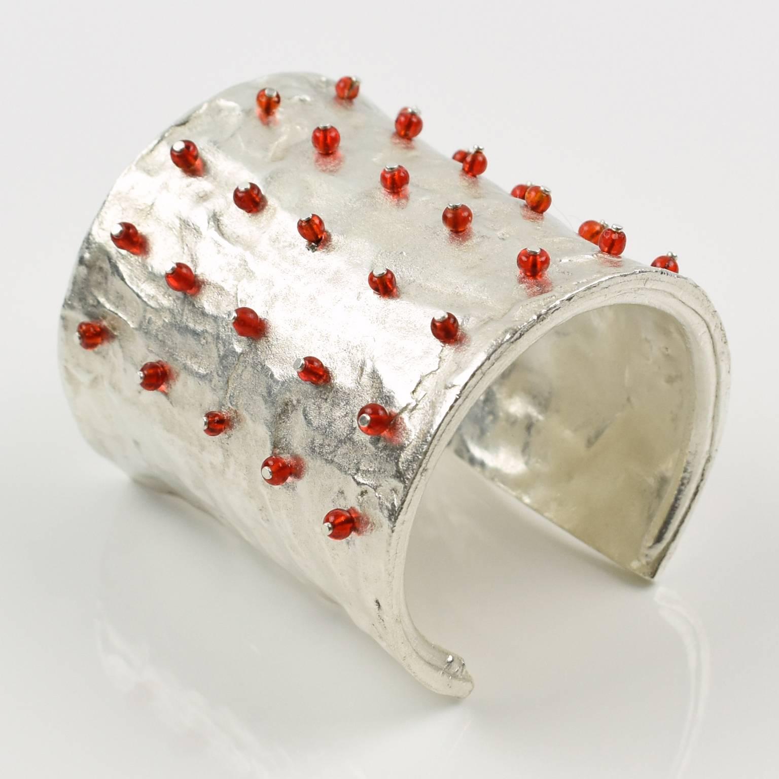 Stunning modernist silver plate cuff slave bracelet by Nelly Biche de Bere Paris. Chunky massive oversized bangle with brutalist carved and hand-made feel design, topped with tiny ruby red glass beads. Marked in the inside: 'Biche de Bere' and