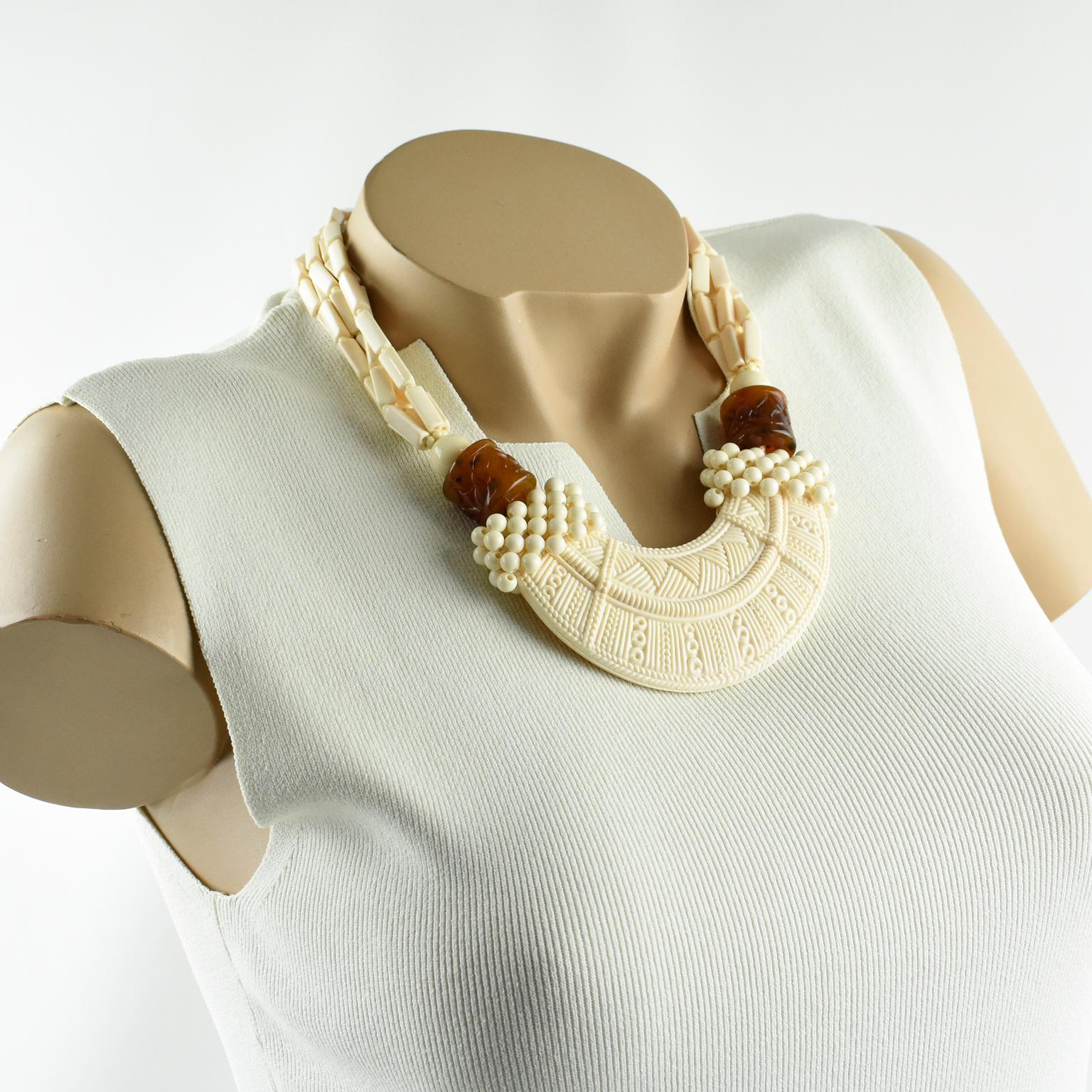 Elegant Angela Caputi, made in Italy resin choker beaded necklace. Working on off-white or ivory color with faux tortoise color contrast, this necklace has ethnic inspired design. Large front resin bib with African tribal carving compliment with