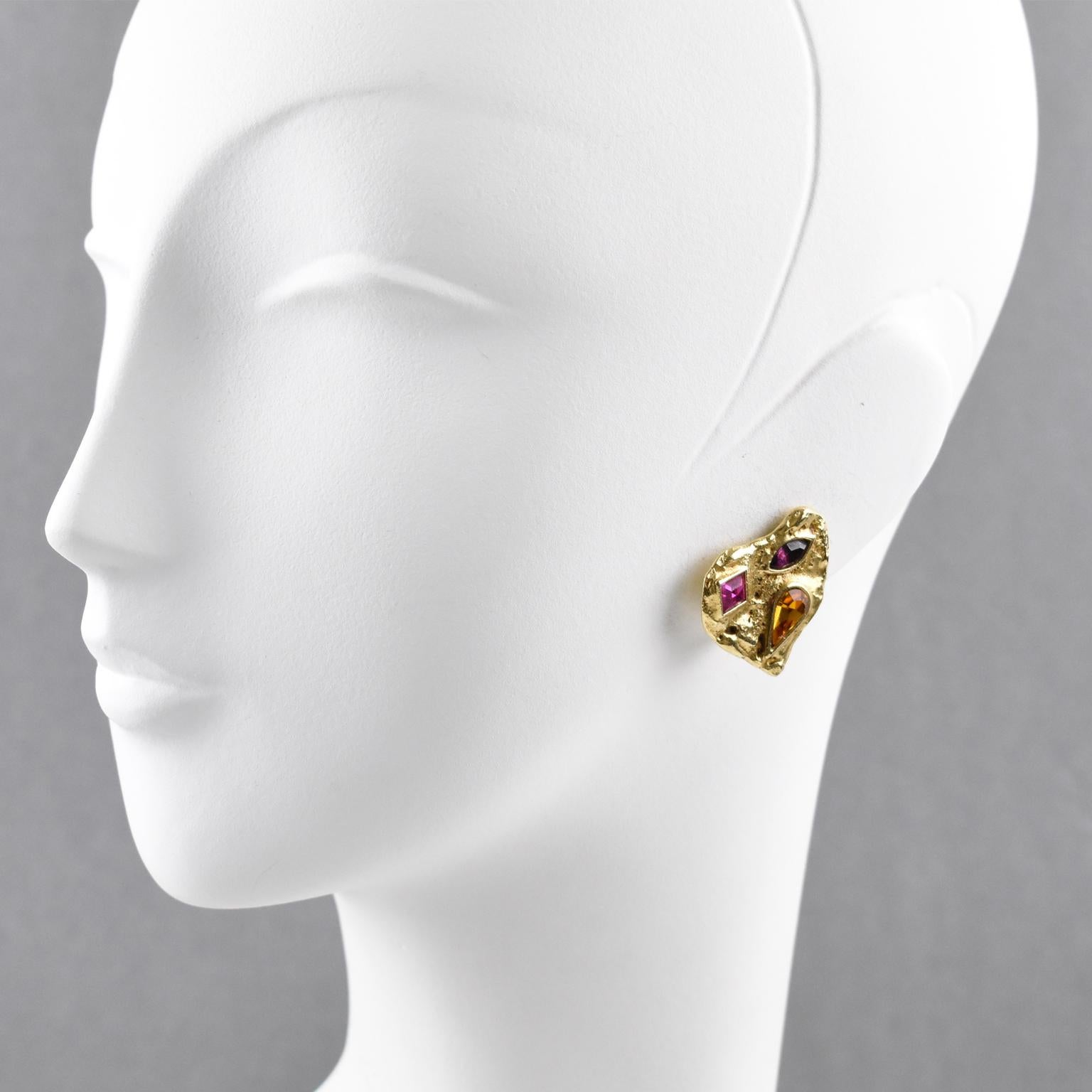 Elegant Yves Saint Laurent Paris signed clip on earrings. Abstract heart shape, gilt metal all textured ornate with multicolor glass rhinestones. Signed at the back with YSL pierced logo on clip and engraved underside: 'Made in