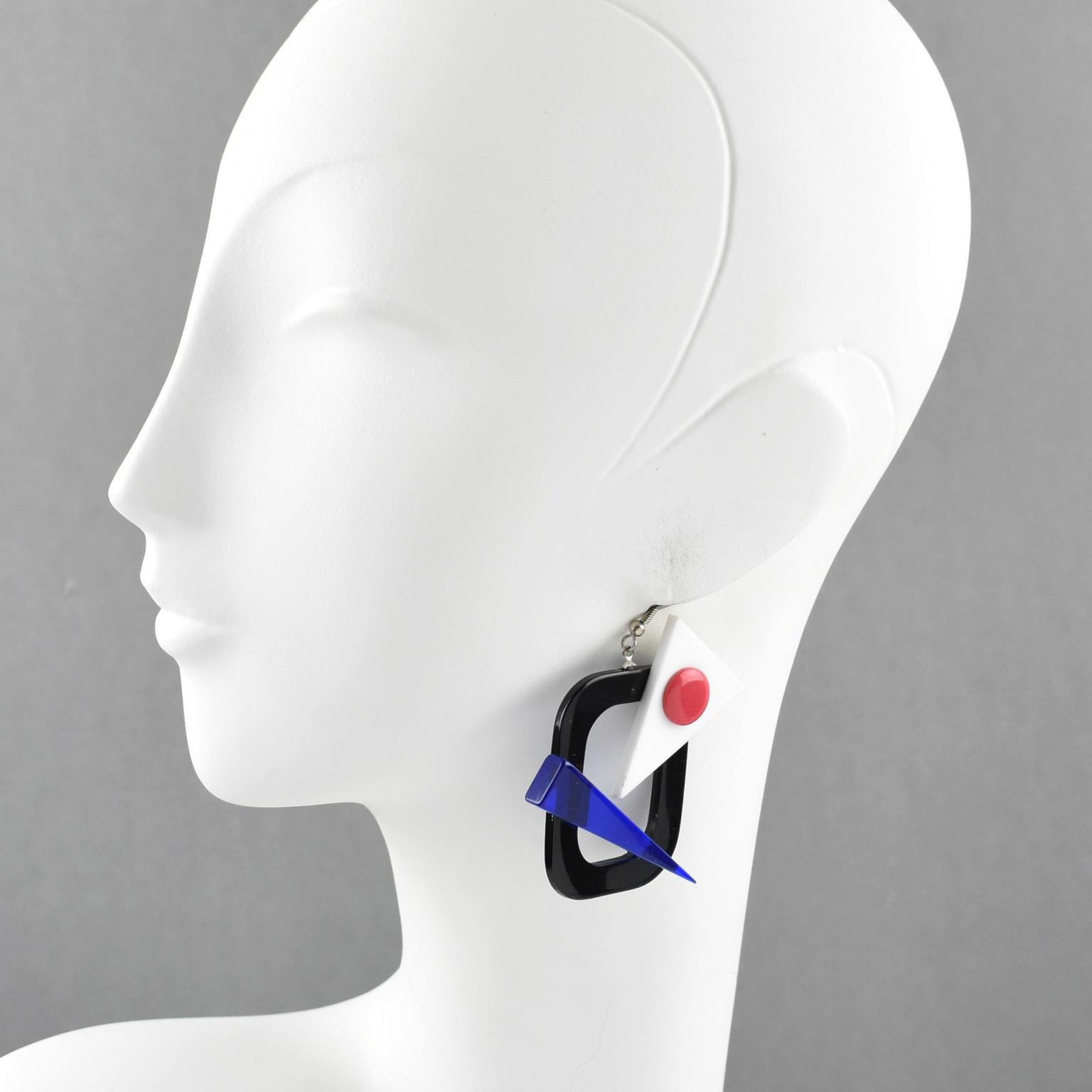 Stunning Italian Studio Memphis style oversized pierced earrings. Featuring all hand-made primary colors Lucite with geometric and see thru carving. Assorted tones of white, black, red and transparent blue. No visible signature. For pierced