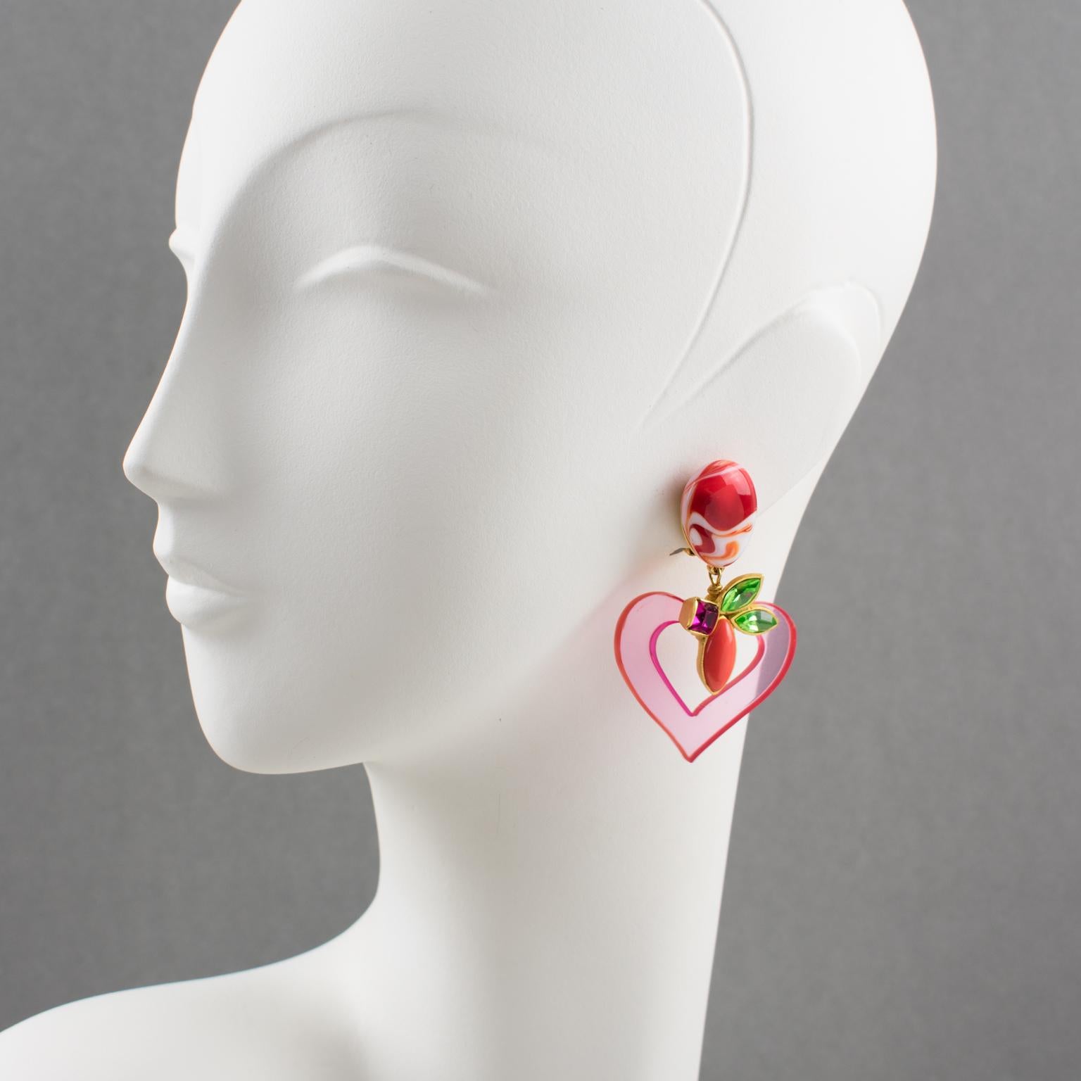 Lovely Christian Lacroix Paris signed clip on earrings. Featuring gilt metal framing dangling shape, ornate with carved and see thru transparent pink resin resin heart and topped with Murano Art Glass cabochon and multicolor glass rhinestones.