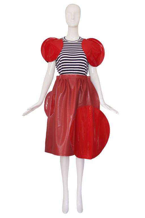 2014 Junya Watanabe for Comme des Garcons red matte vinyl skirt with large glossy vinyl circle appliqués. Zip and snap closure at side. Size tag S. In excellent condition - most likely never worn.
MEASUREMENTS:
SKIRT
Waist: 28