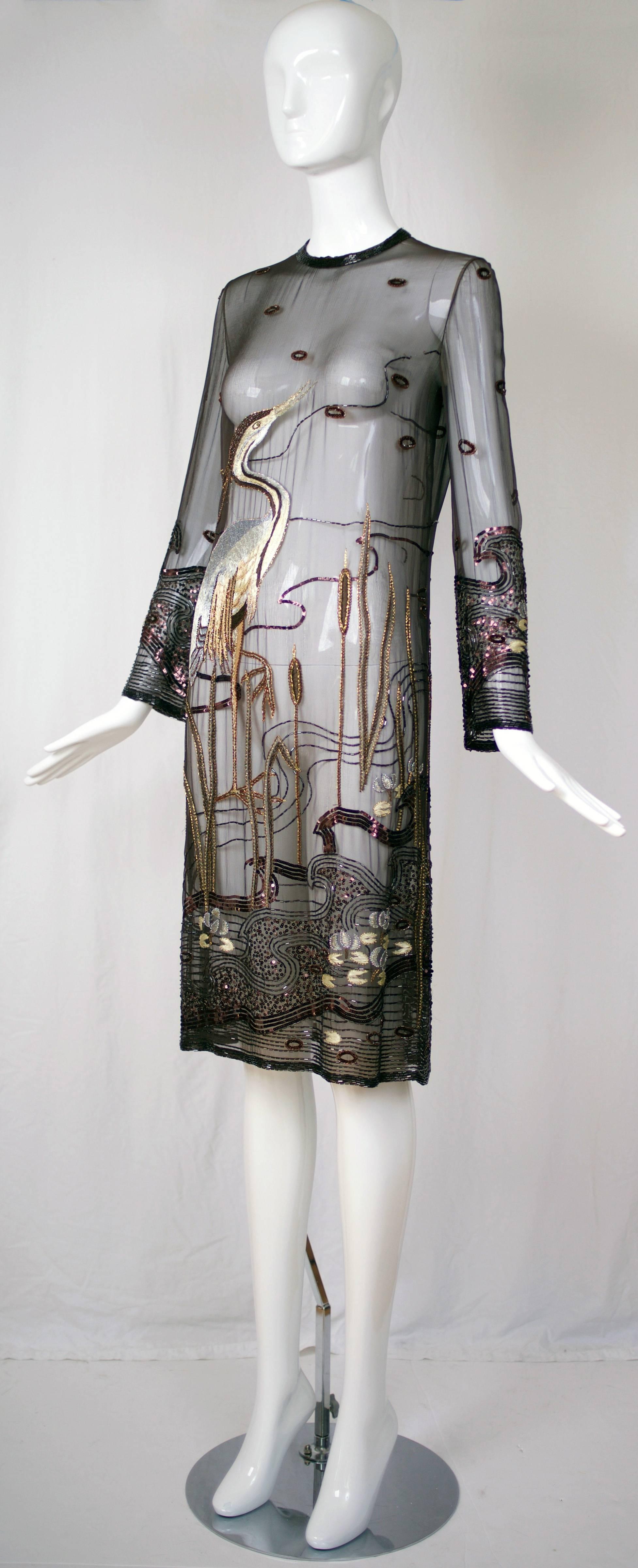 A circa 1980 Guy Laroche haute couture brown silk chiffon illusion cocktail dress that is embroidered with metallic thread, beads and sequins in the image of a heron standing on one leg in the midst of a marsh  - rendered in shades of brown, copper,