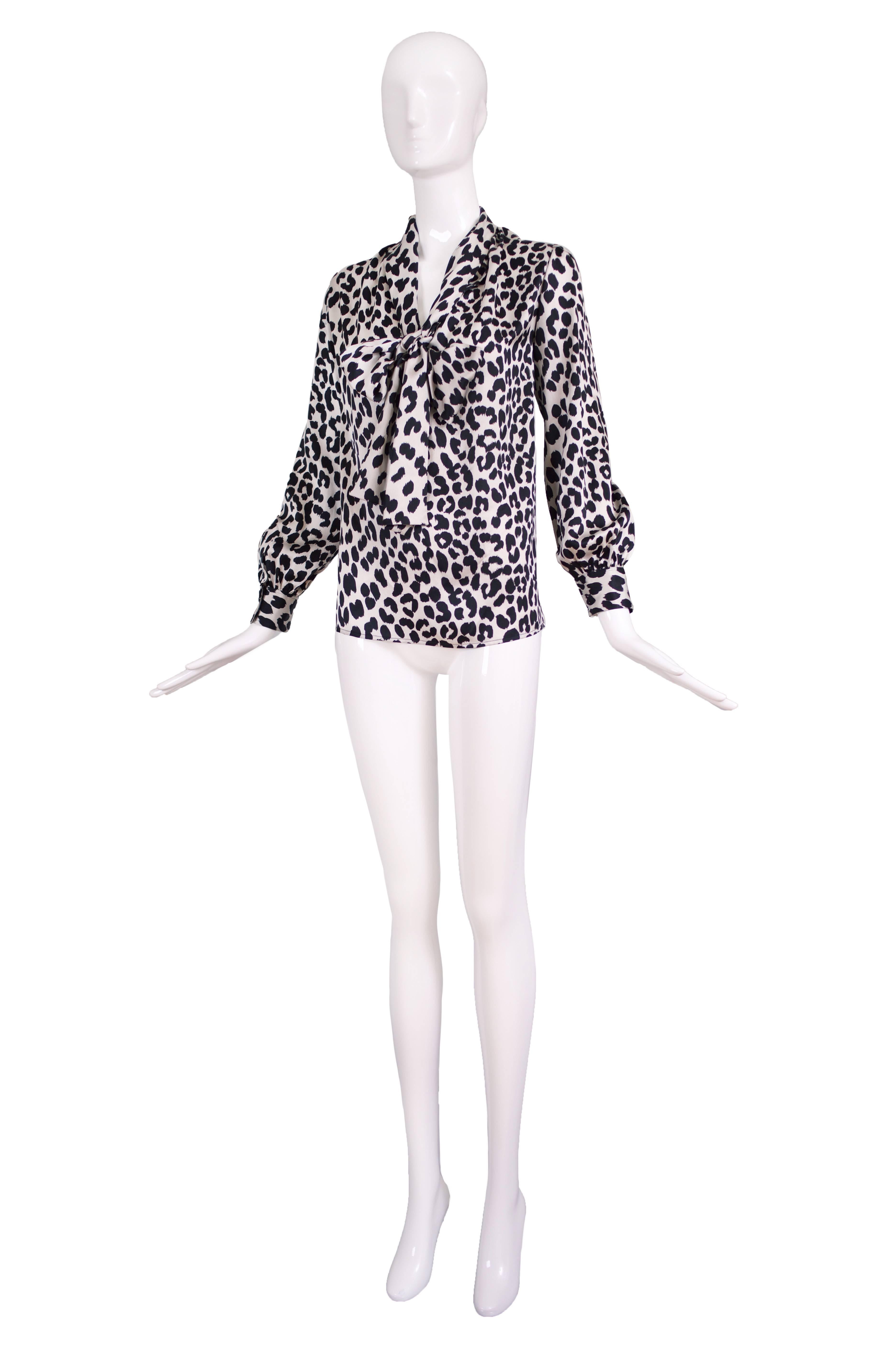 1970's Yves Saint Laurent black and white silk leopard print blouse w/neck ties - can be worn tied high or in a low hanging bow. In excellent condition. Size tag 36. Please consult measurements.
MEASUREMENTS:
Bust - 44
