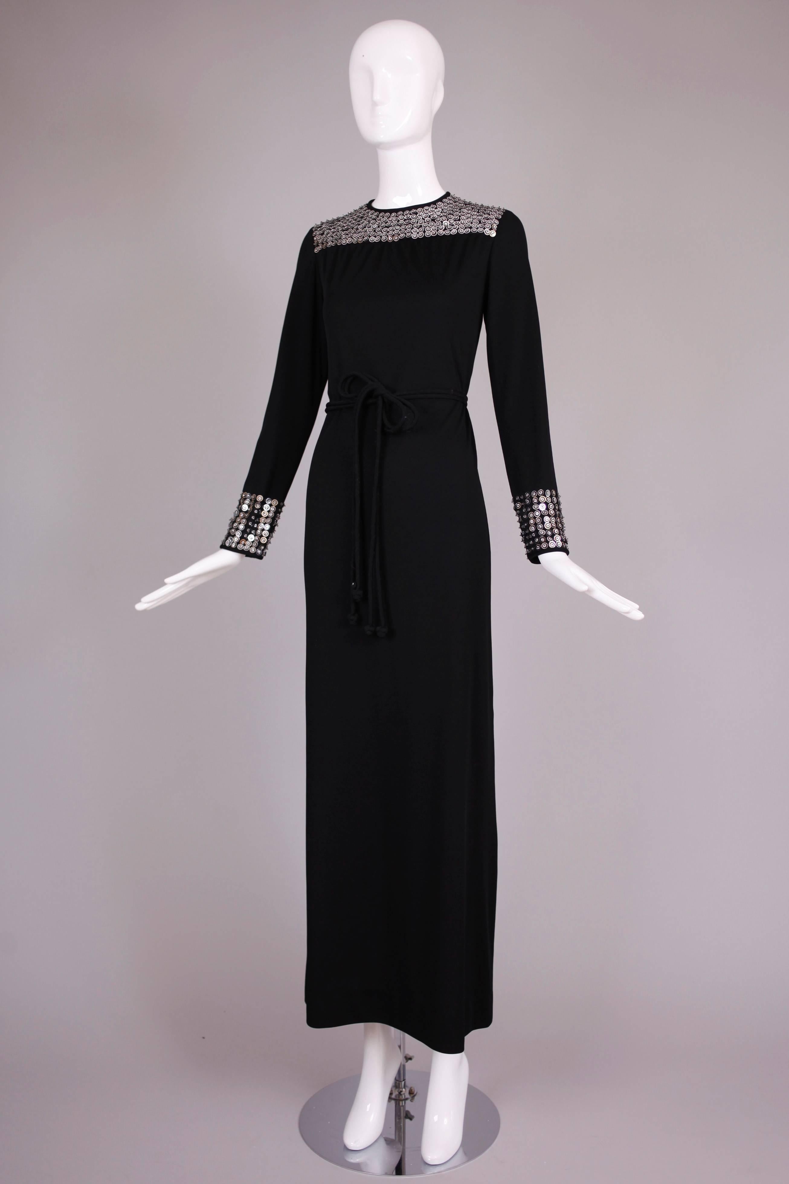 1970's Rizkallah for Malcolm Starr black evening dress with silver beaded & sequined detail at the neck and sleeves - comes with self-tie belt. In excellent condition - missing a few sequins. No size tag so please consult