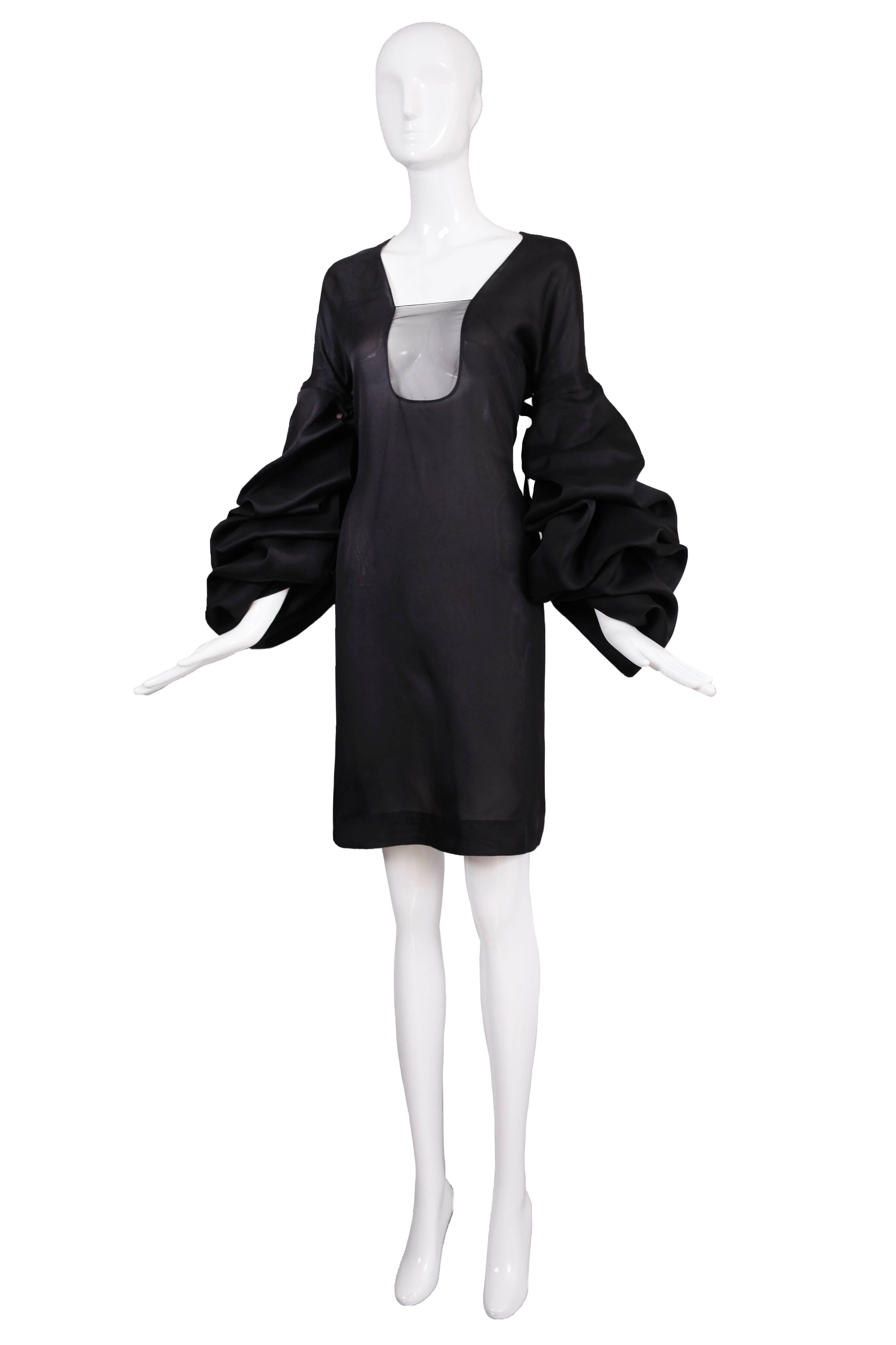 Iconic 2002 A/H Tom Ford for Yves Saint Laurent black silk cocktail dress with triple tier detachable balloon sleeves. This dress was look #34 on the runway and modeled by Giselle Bunchden in the Tom Ford book. In excellent condition. Size 40.