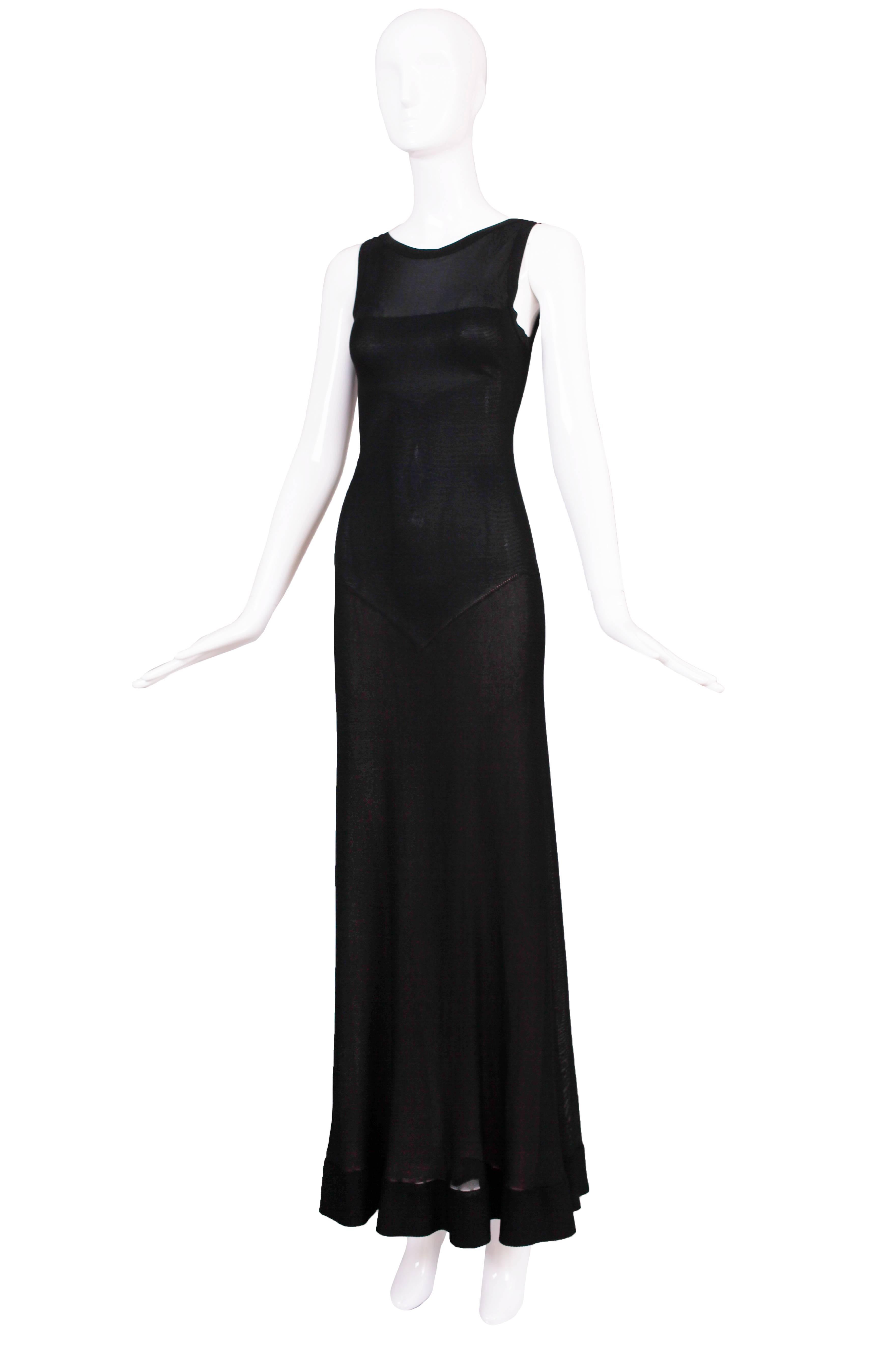 Circa 2005 Azzedine Alaia black fitted evening gown with zipper closure up the back. At the back skirt there are slight gathers as well as a nude-colored layer underneath the skirt. In excellent condition. Size tag 38.
