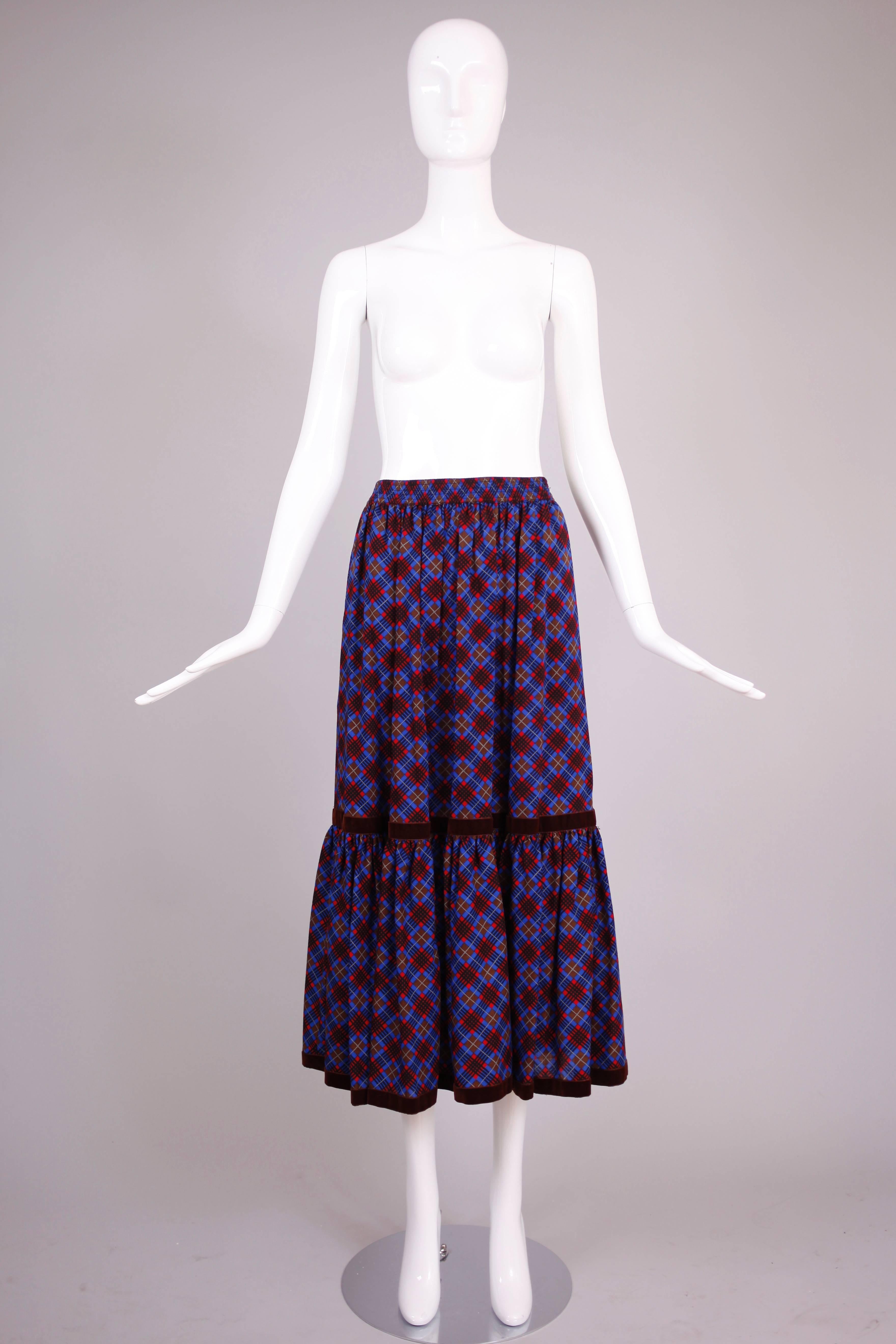 1970's Yves Saint Laurent plaid tiered lightweight wool prairie skirt with brown velvet trim. In excellent condition. Size tag 38.
MEASUREMENTS:
Waist - (approx.) 26