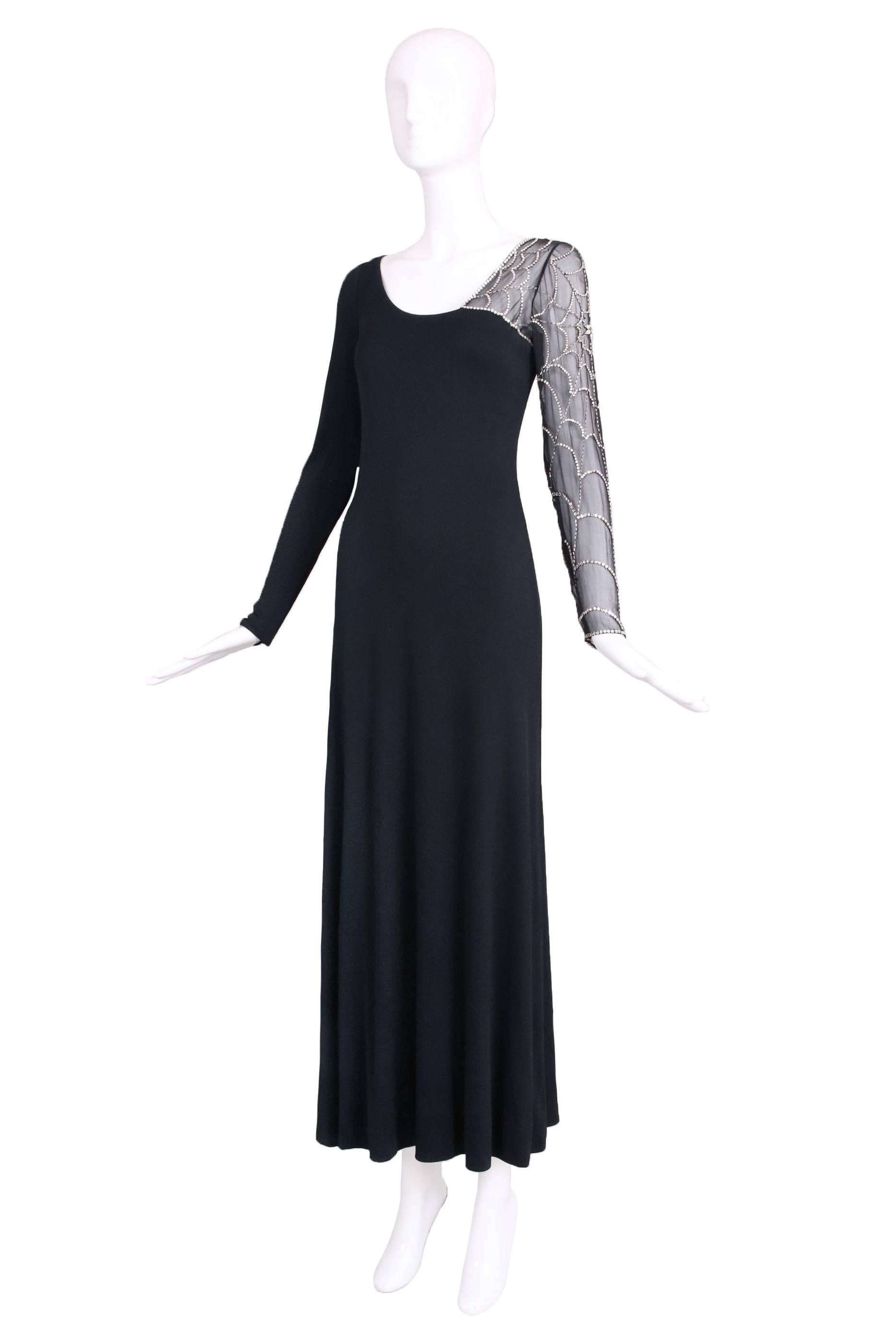 Mollie Parnis black double ply silk jersey evening gown with one transparent chiffon arm beaded and sequined in a spider web design. In excellent condition. No size tag, please see measurements.
MEASUREMENTS:
Bust - 34