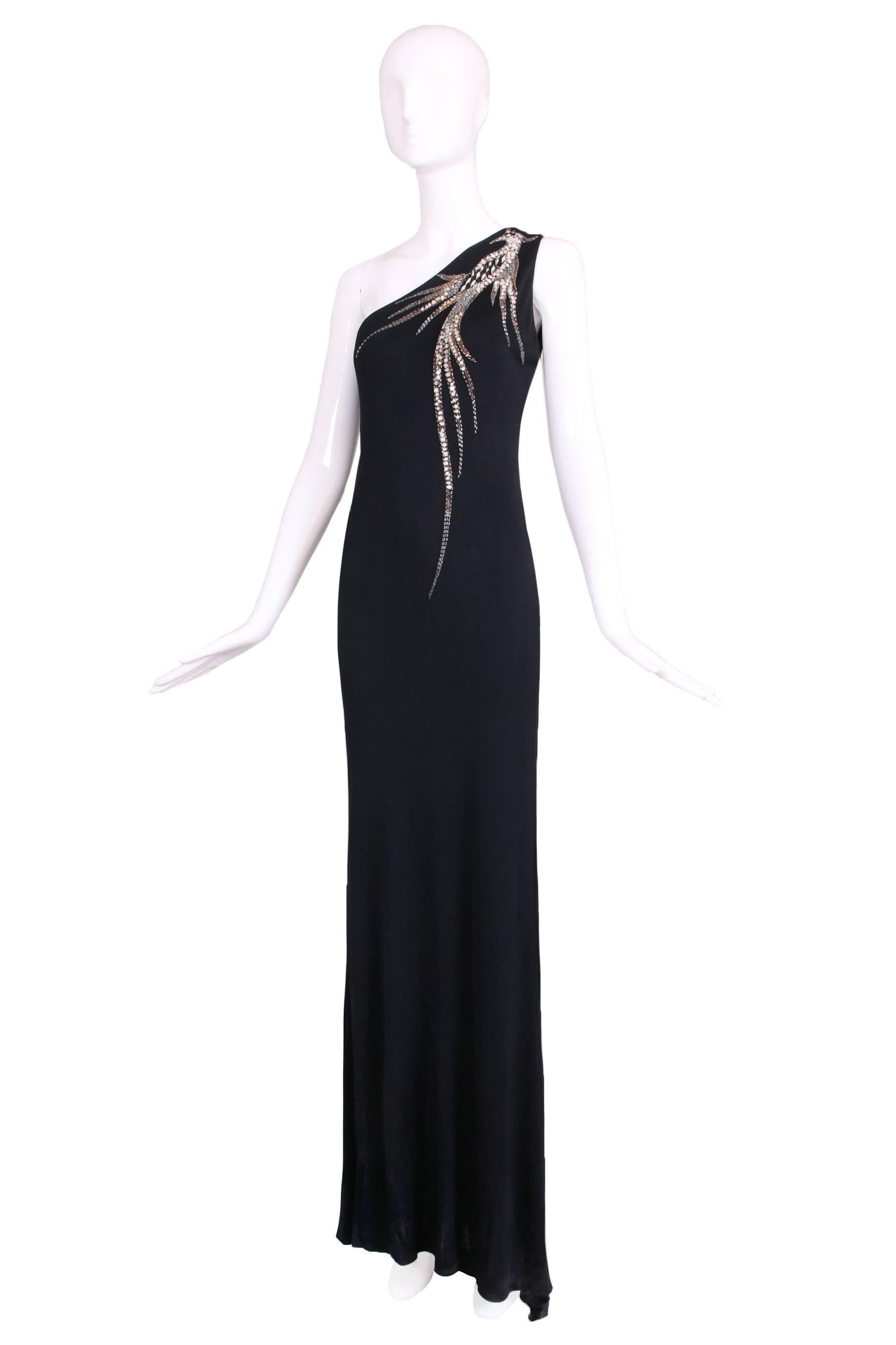 1970's Bob Mackie black silk jersey single-shoulder evening gown with beaded and sequined firebird design. In excellent condition. Please consult measurements.
MEASUREMENTS:
Bust - 35