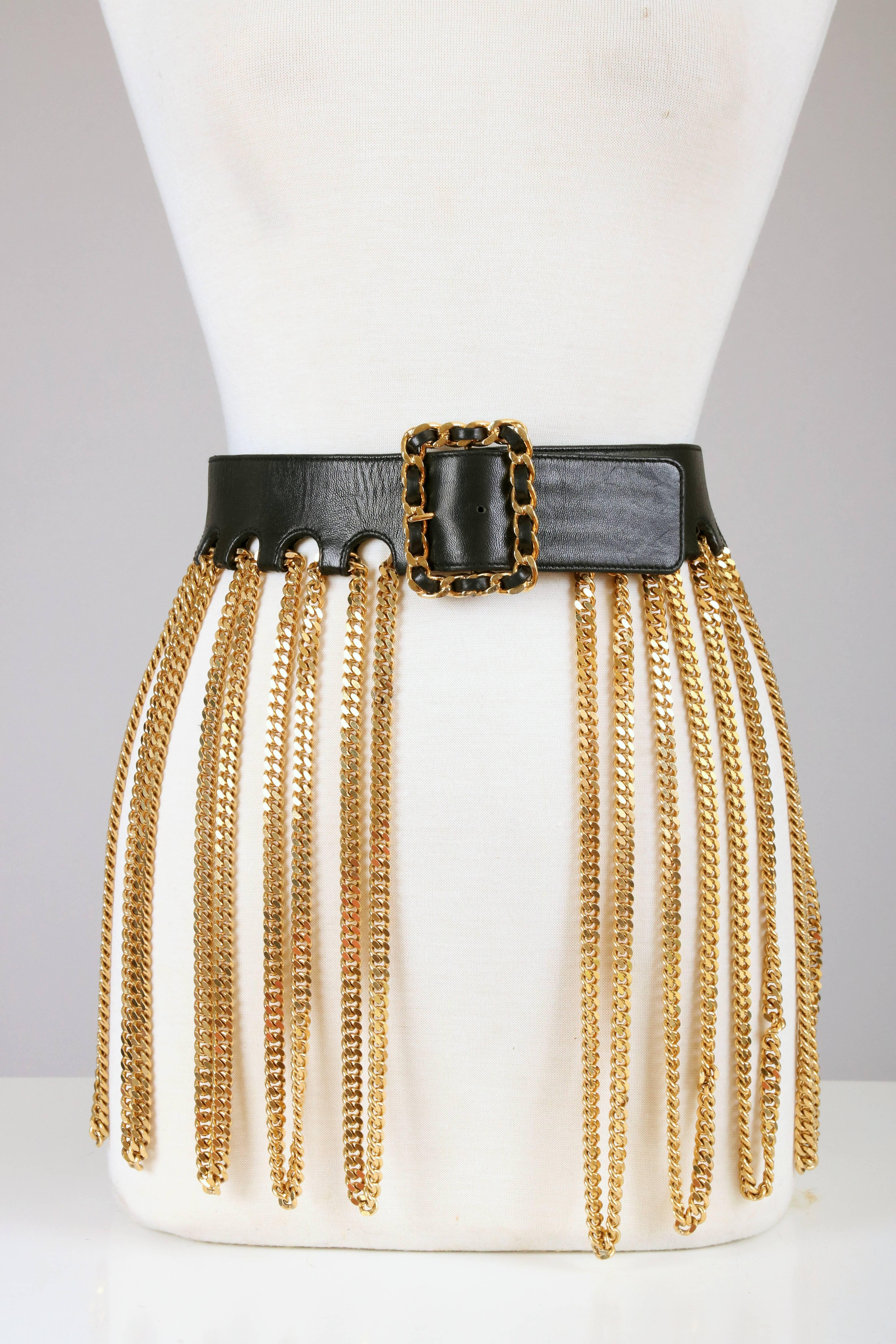 Iconic Chanel vintage black leather and chain belt with buckle made from gold metal hardware and woven black leather. Worn in famous editorial with Linda Evangelista. 
MEASUREMENTS:
Belt Length - 32 1/2