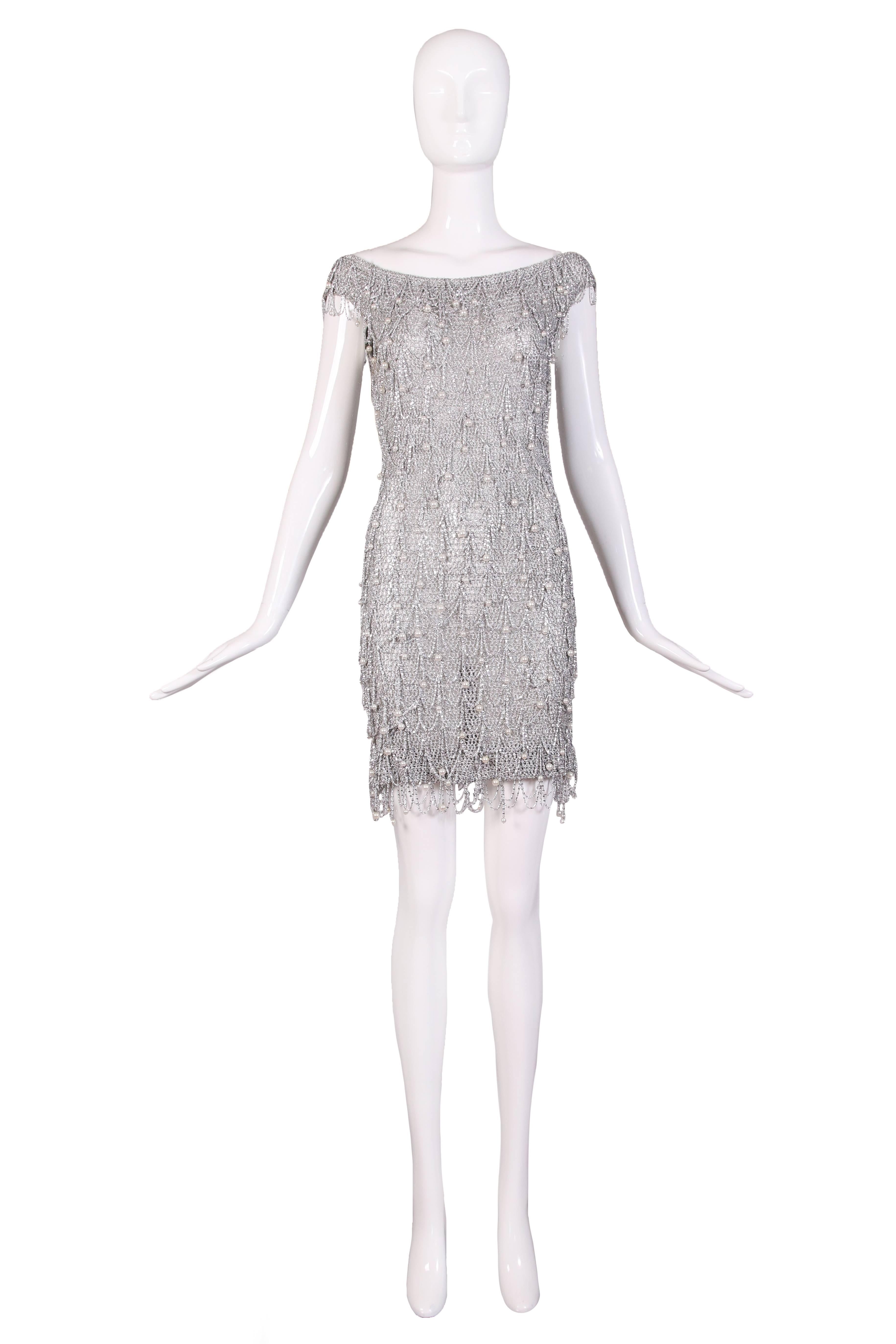 1970's unlabeled Loris Azzaro silver mesh, chain and beaded bodycon mini dress. There is no size tag but this will fit a small or extra small. In excellent condition.