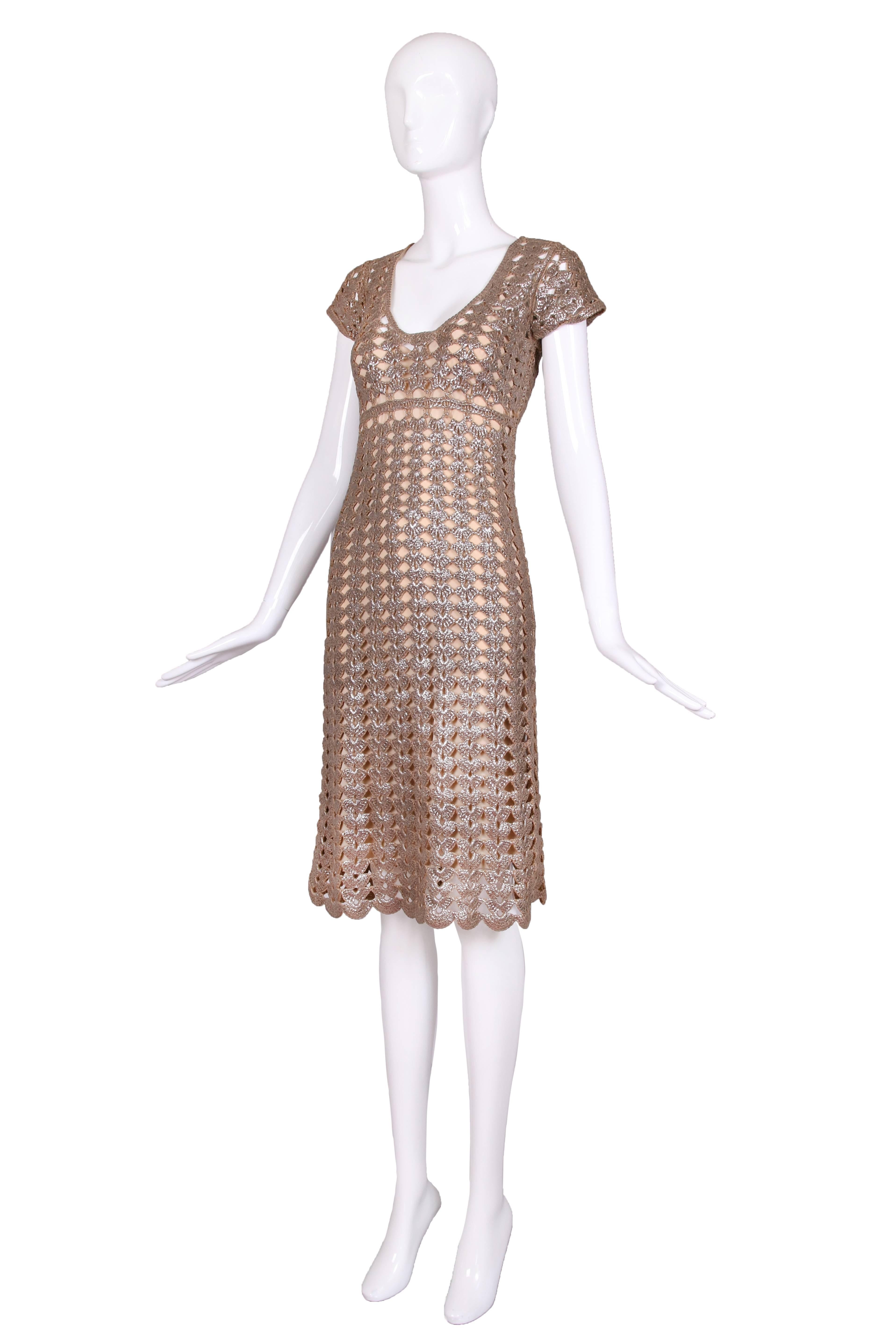 Circa 2007 Prada metallic crochet dress with nude colored slip underneath. The dress features an empire waist, scooped neck and cap sleeves. In excellent condition. Size 38.
MEAUREMENTS:
Bust - 34/36
