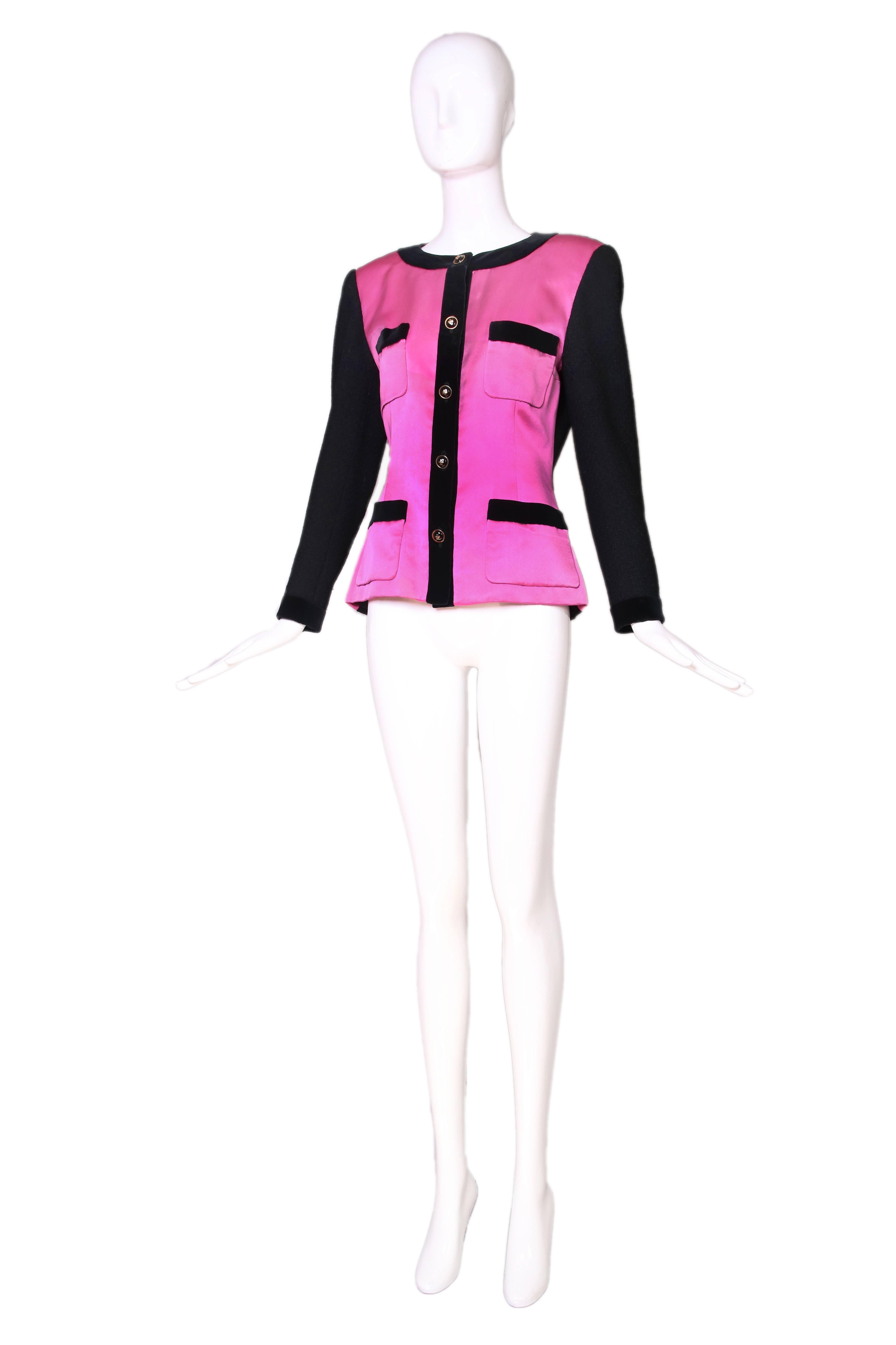 1987 A/H Chanel pink satin and black wool boucle fitted jacket with Four-leaf clover motif button closures at  center front and sleeve cuffs. Jacket is trimmed with black velvet at the neckline, placket, sleeve cuffs and at the top of the four