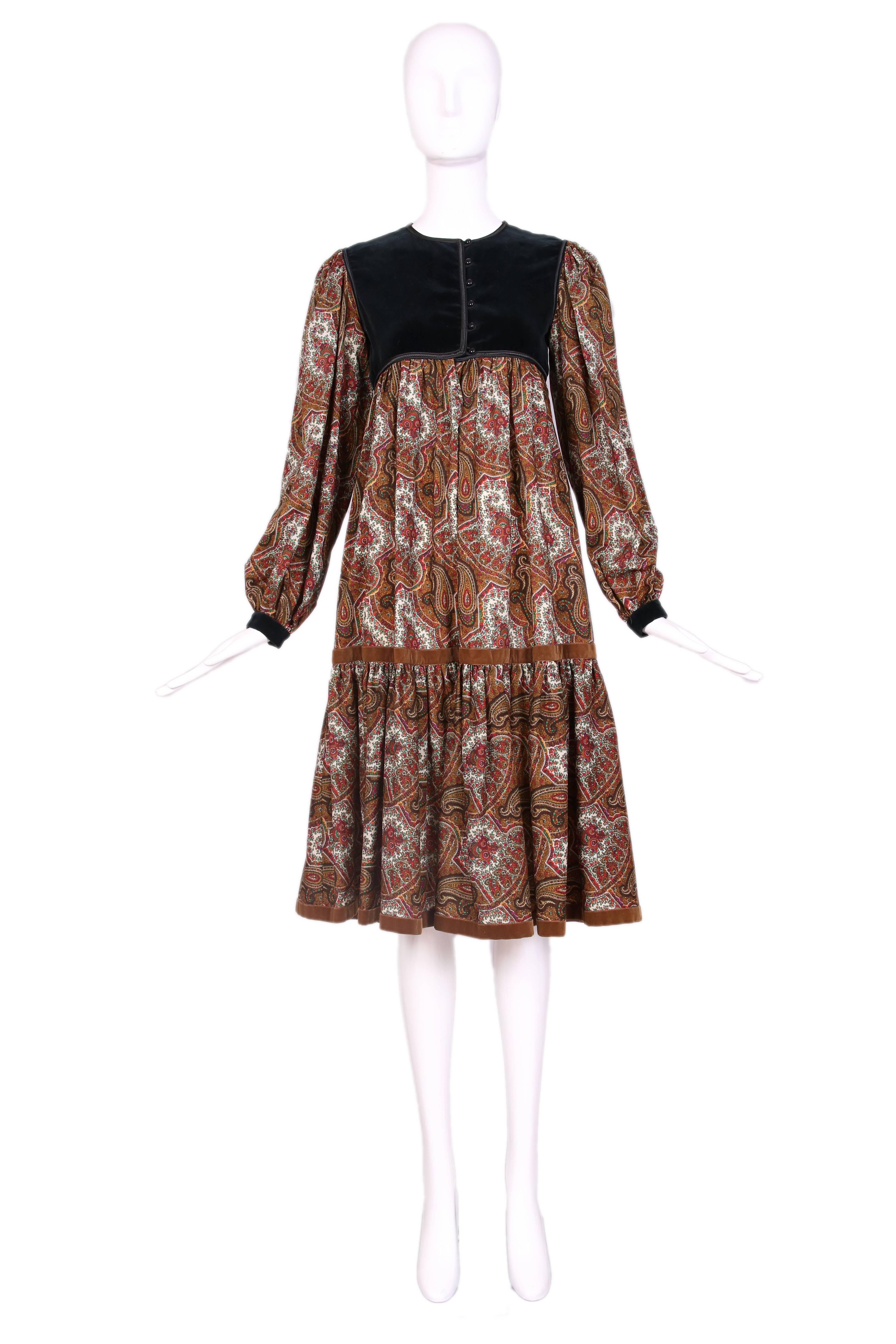 Vintage Yves Saint Laurent YSL multi-colored paisley print wool long sleeve tiered peasant dress with black velvet bodice and cuffs. Brown ribbon trim at drop waist tier and hem. In excellent condition. Size EU 36.
MEASUREMENTS: 
Bust -