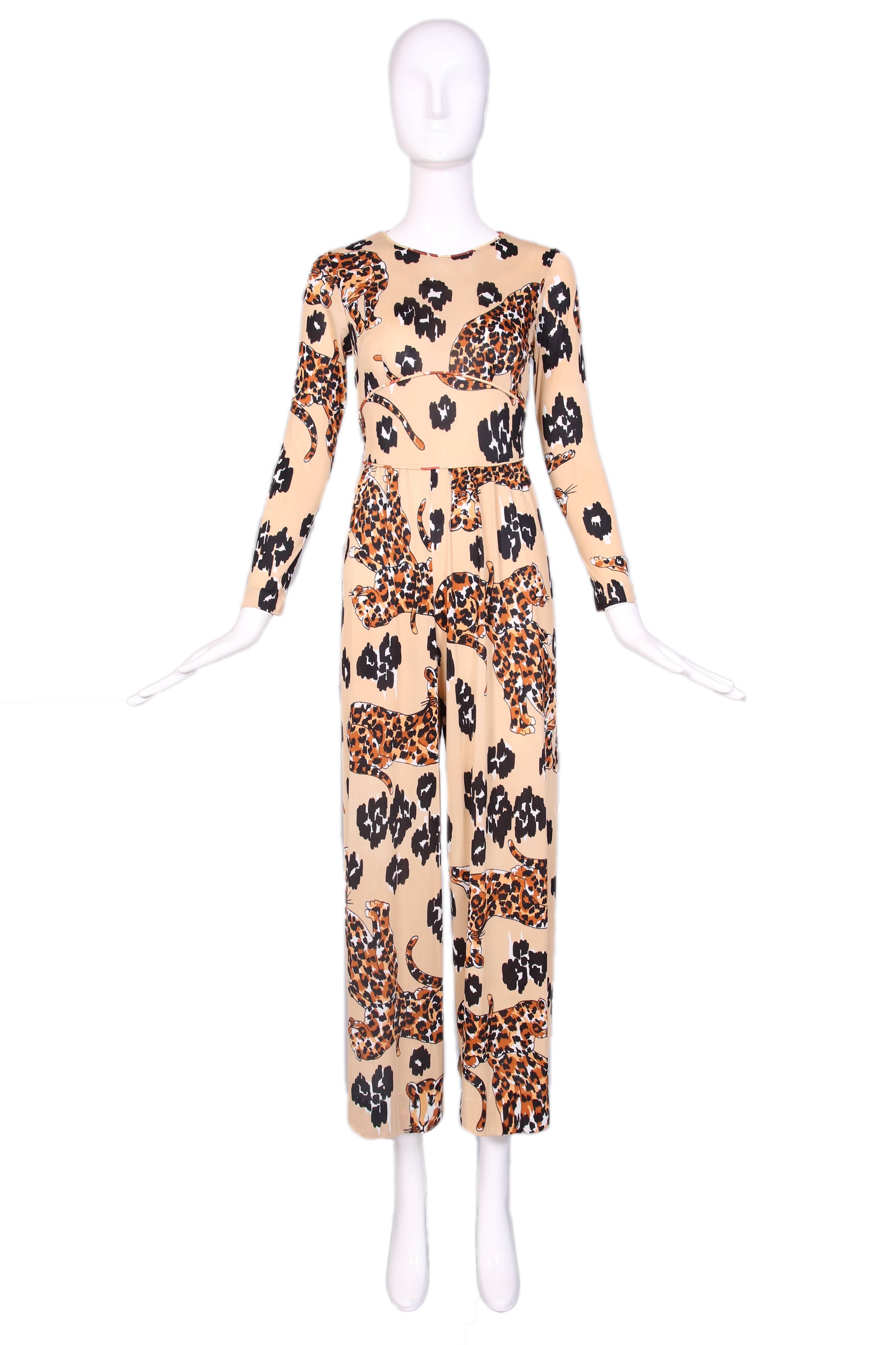 1970's leopard print print jersey jumpsuit with long sleeves and attached waist ties. In very good condition with a handful of tiny holes. No size tag. 
MEASUREMENTS:
Shoulder - 14"
Bust - 30"
Waist - 26"
Hip - 48"
Inseam -