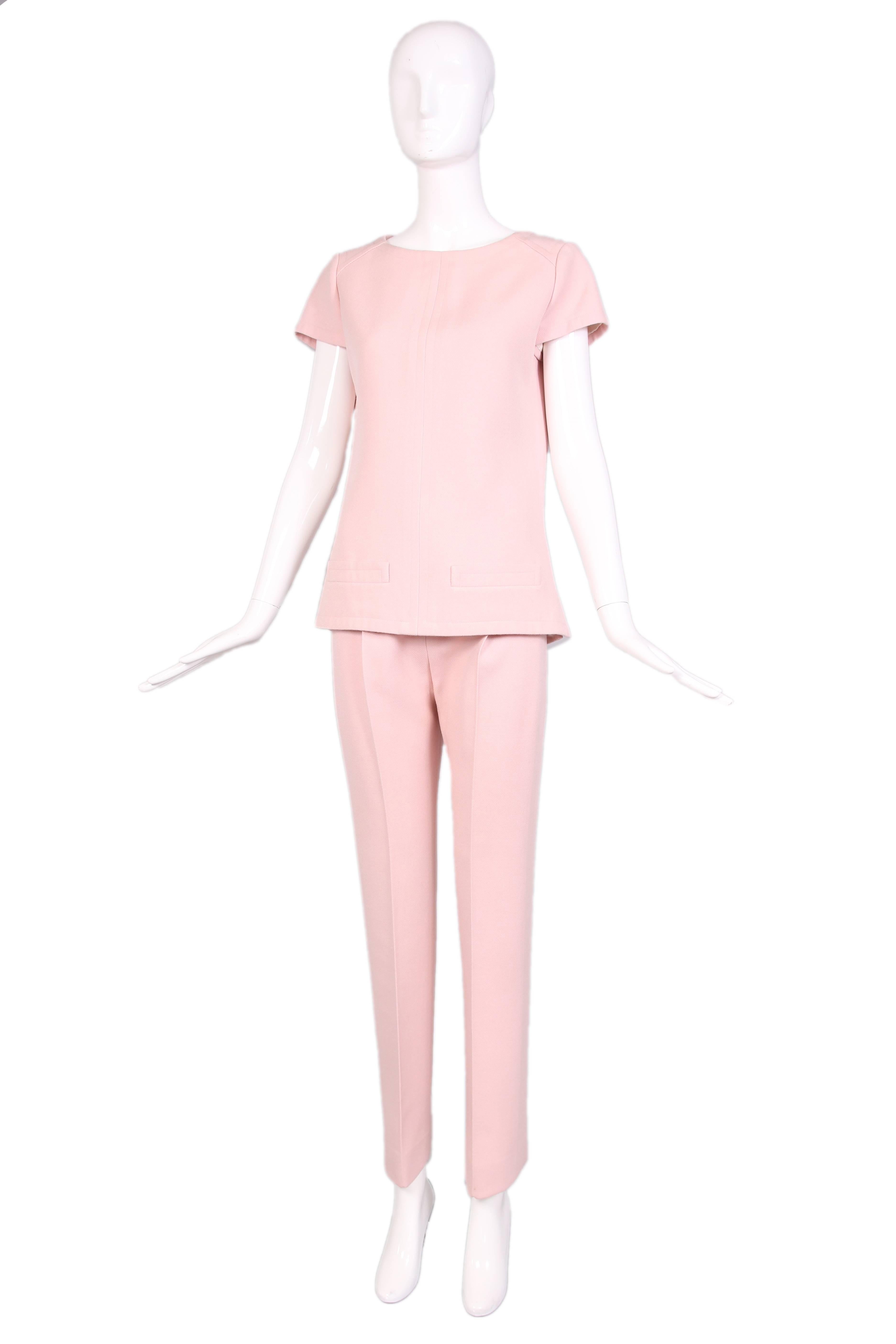1960's Courreges for Harrods baby pink cap sleeve tunic top with two front pockets and matching trousers. 100% silk lining in both pieces. In excellent condition. No size tag, consult measurements.
MEASUREMENTS:
Top:
Bust - 38