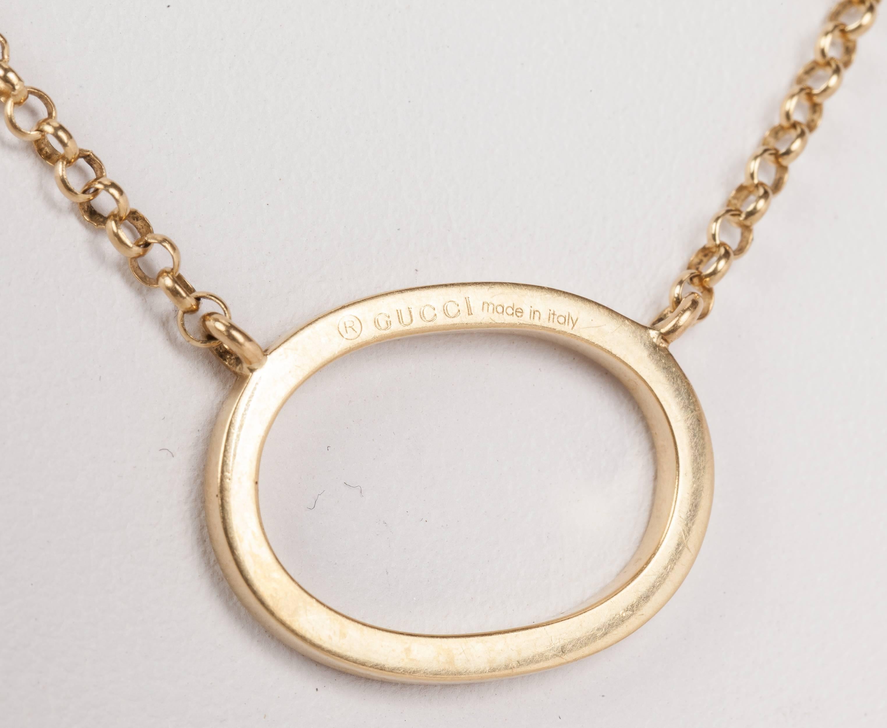 Gucci 18K yellow gold oval pendant necklace. The total weight of the necklace is 6.6 grams. The necklace is 16 3/4