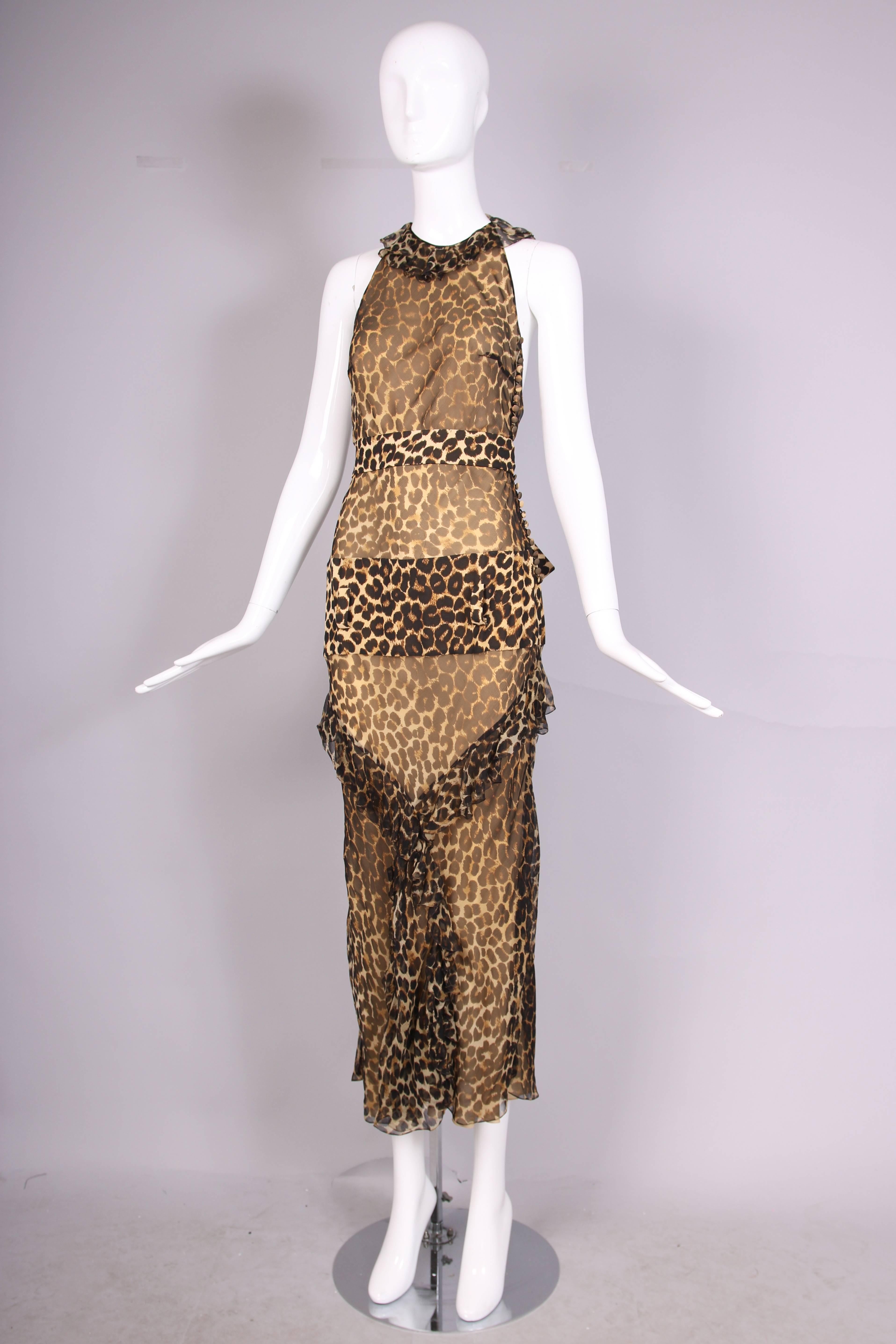 1990's John Galliano sheer silk chiffon leopard print halter dress with dropped waist and matching belt. Gown features ruffled neck ties and ruffle trim design at front of skirt. Button closure at bodice side. In excellent condition. Size US