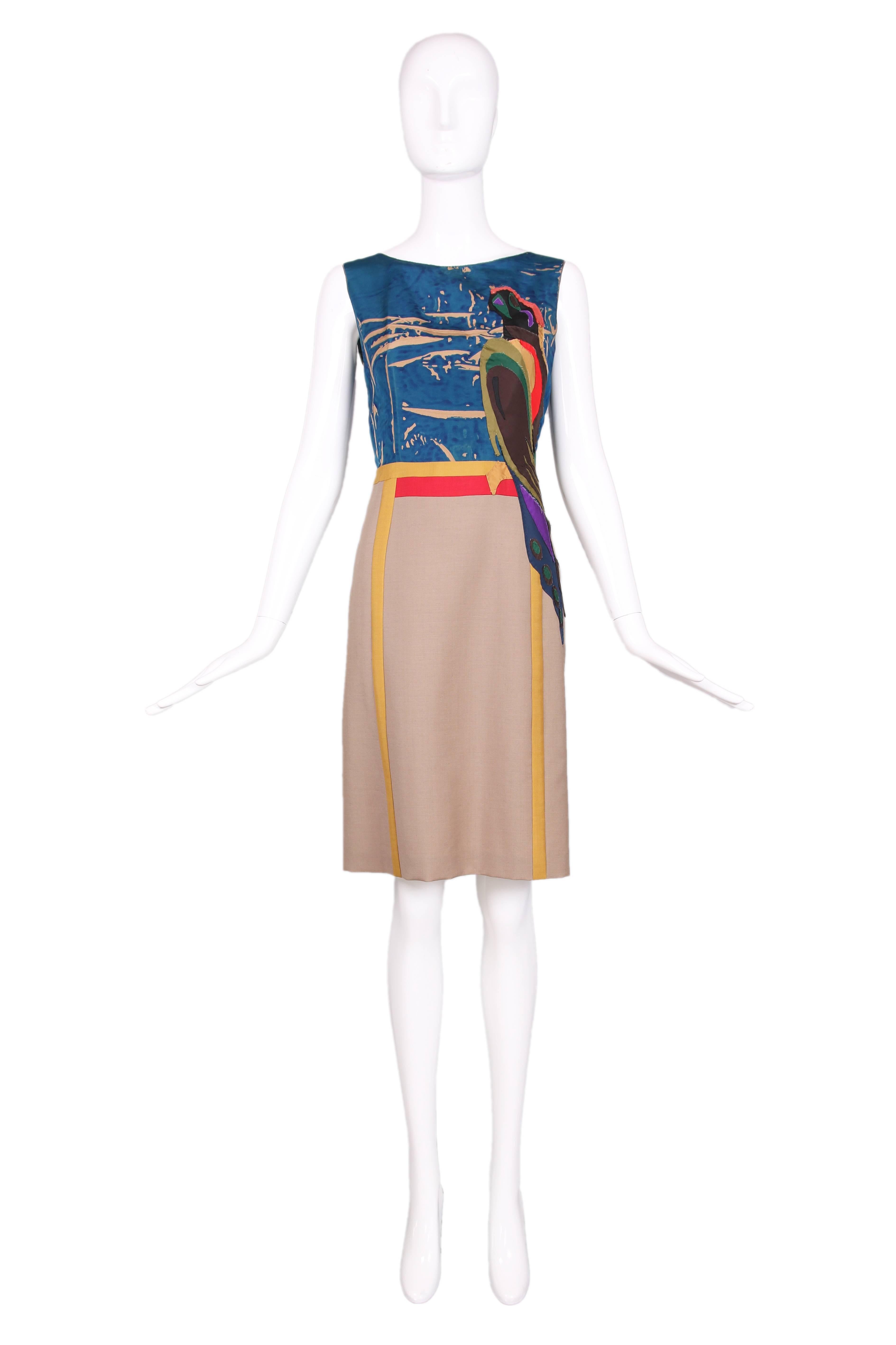 2005 Prada color blocked sleeveless dress featuring an appliquéd parrot at left bodice that continues at the skirt. Bodice is made of silk and the skirt is a lightweight wool. In excellent condition. 
MEASUREMENTS:
Bust - 34