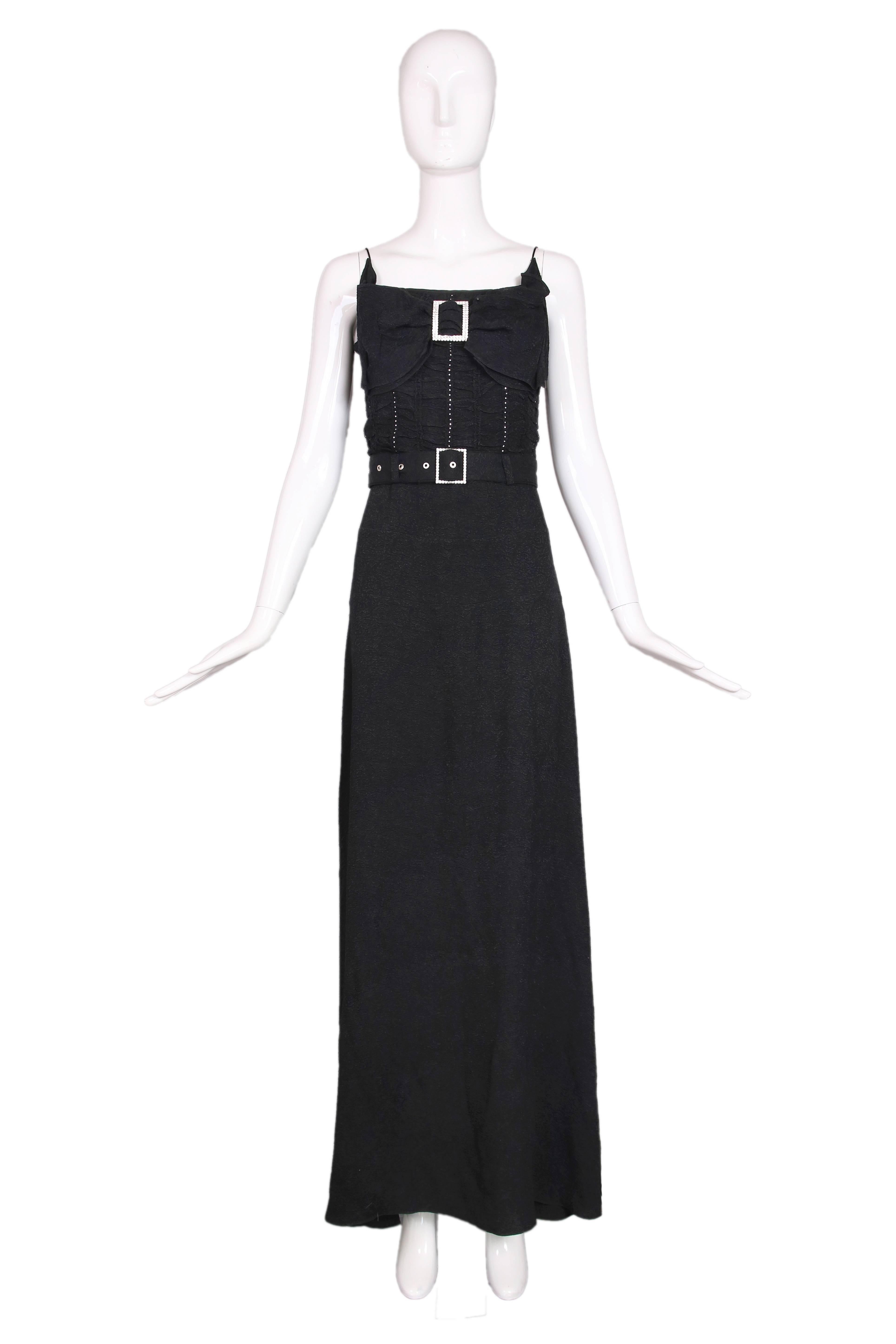 John Galliano black rayon puckered crepe evening dress w/frontal decorative bow at the chest and rhinestone detail that goes down the bodice. Rhinestone buckle detail at bow and waist belt. Fully lined in silk. In excellent condition. Size US