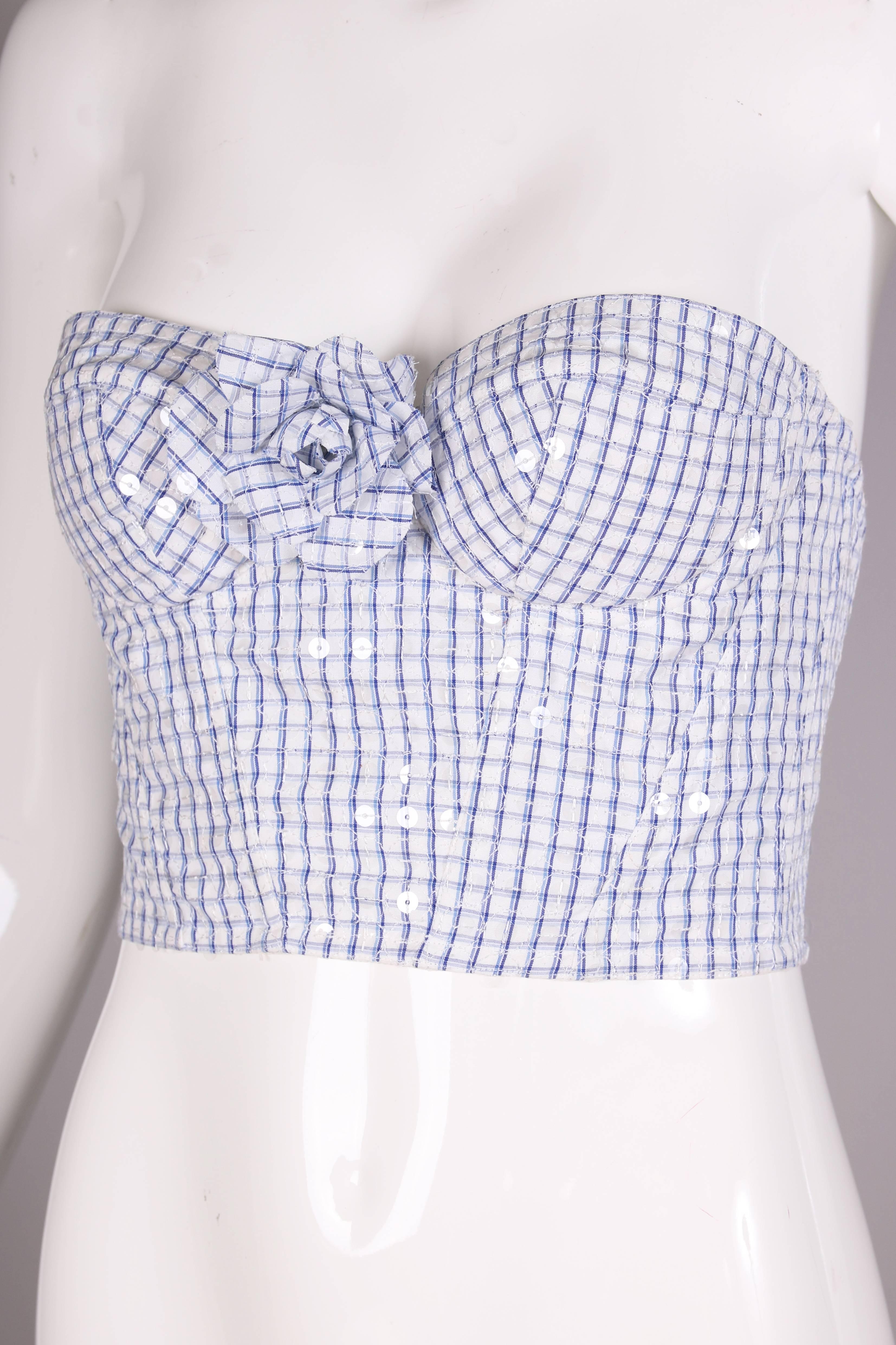 1995 Chanel blue & white gingham bustier with clear sequins. Elasticized ruching at back clasps for stretch and a matching camellia pin that can be detached. Lined in 100% silk. In excellent condition. Size EU 38.
MEASUREMENTS:
Bust - 34