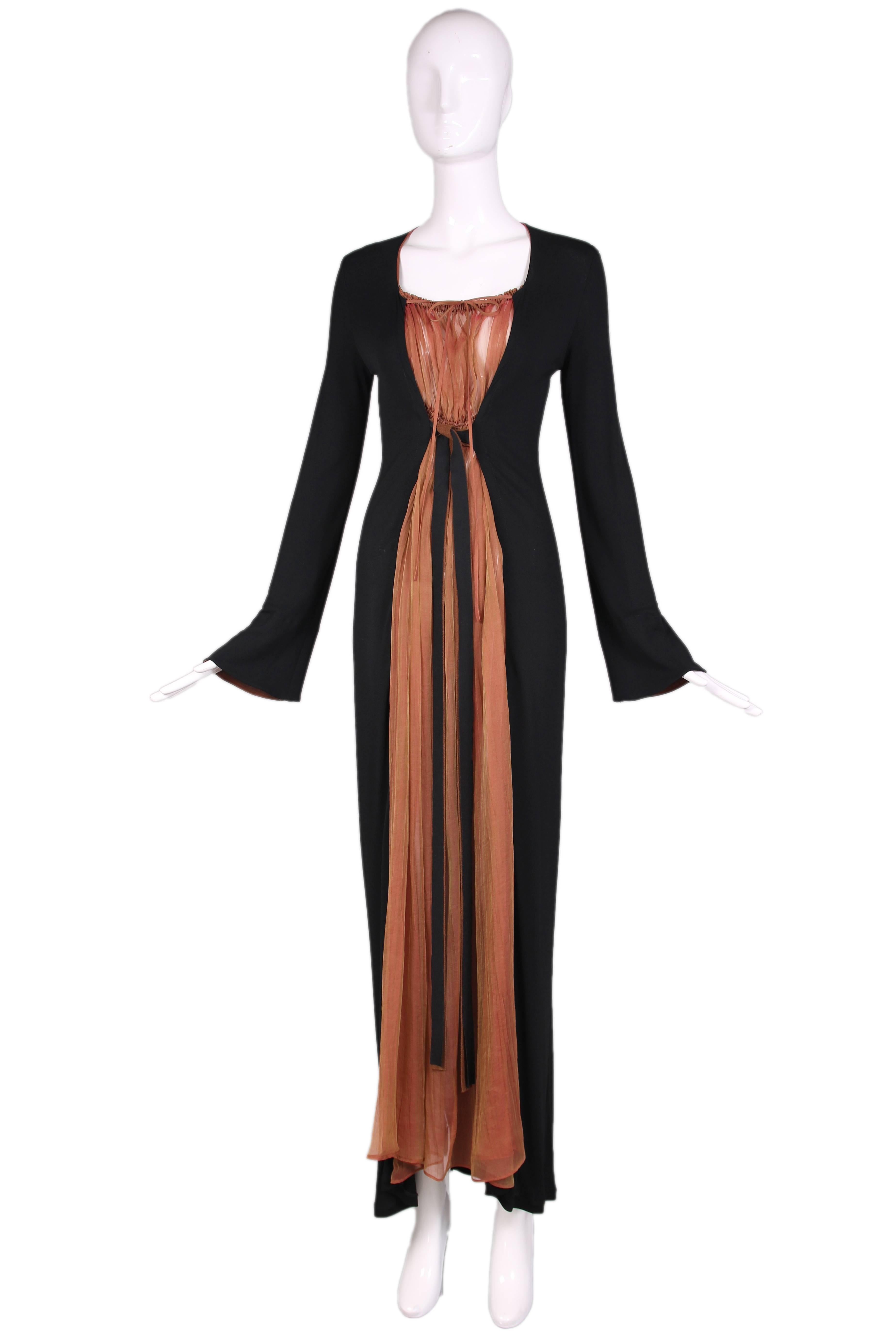 Jean-Paul Gaultier black jersey maxi dress with bronze chiffon inset and subtle bell sleeves. Chiffon inset has a heavily pleated elastic neckline as well as waist and thin chiffon ties at neckline. Waist ties are jersey on one side and felt on the