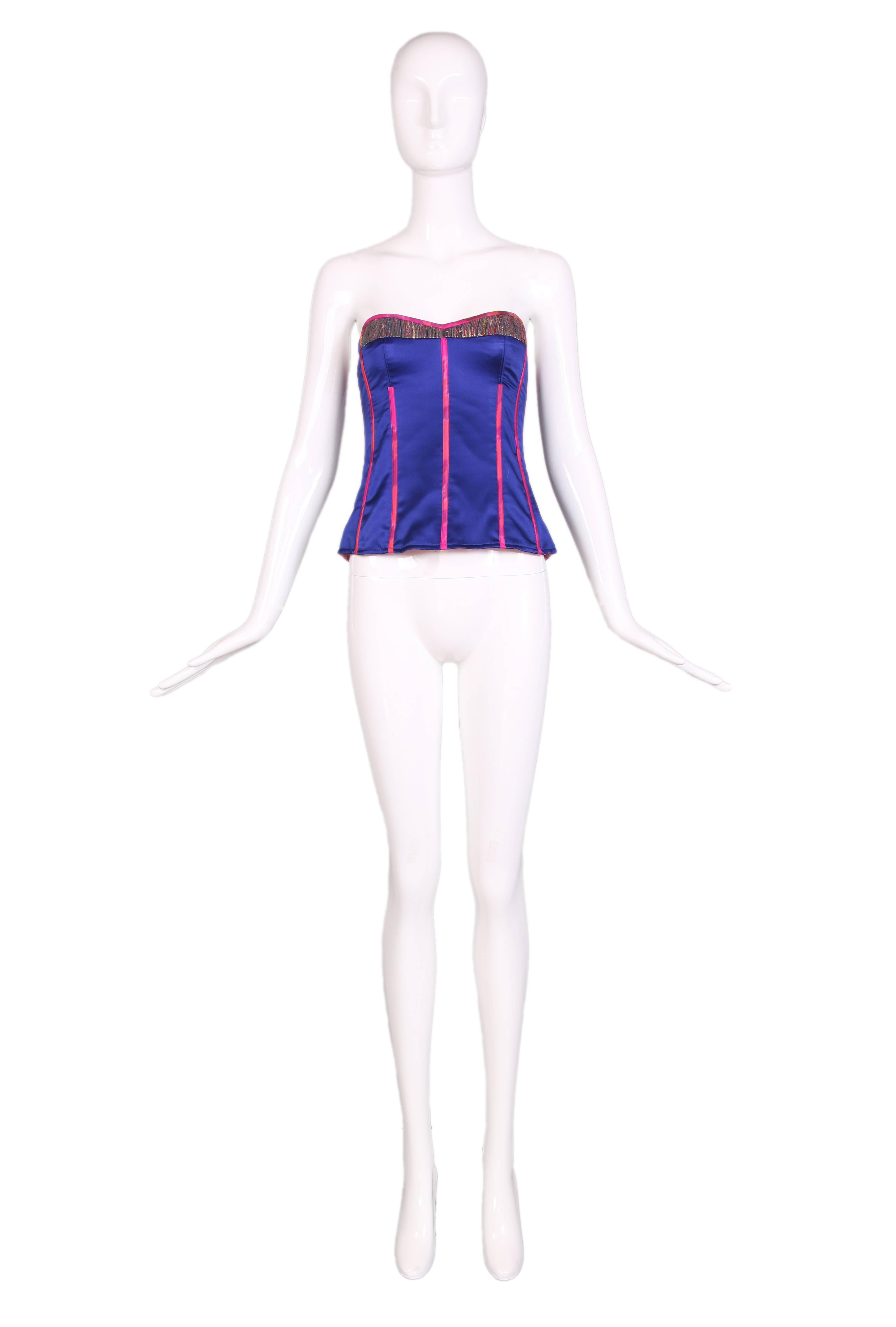 Tracy Feith royal purple silk bustier with hot pink trim and multi-colored lurex ethnic inset detail at top. Back zipper closure. In excellent condition. Size US 1.
MEASUREMENTS:
Bust - 32