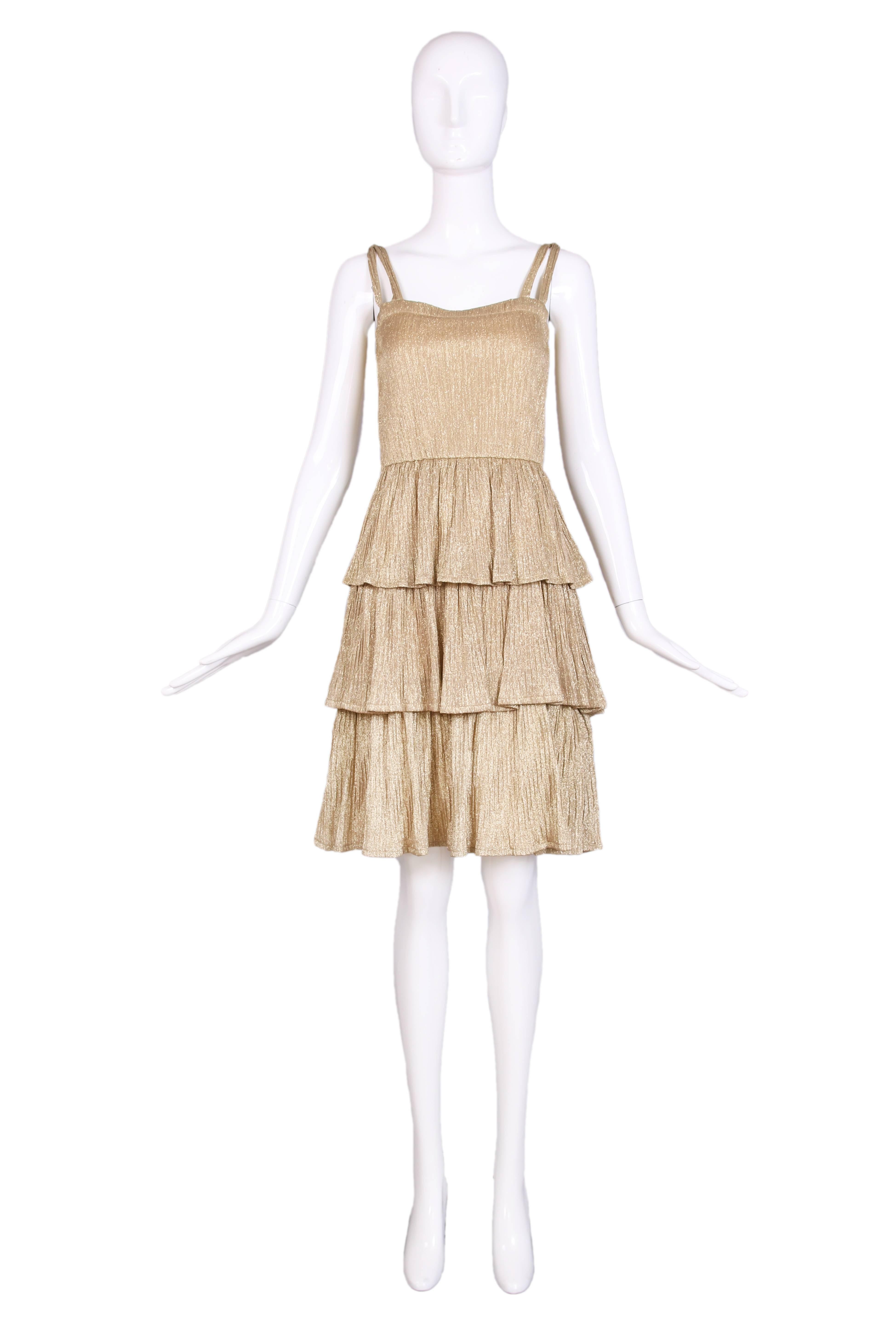 1970's gold lurex multi-tiered pleated party dress. Elastic waist and double straps that connect at the top of the shoulder. In excellent condition. No size tag, please consult measurements.
MEASUREMENTS:
Bust - 32