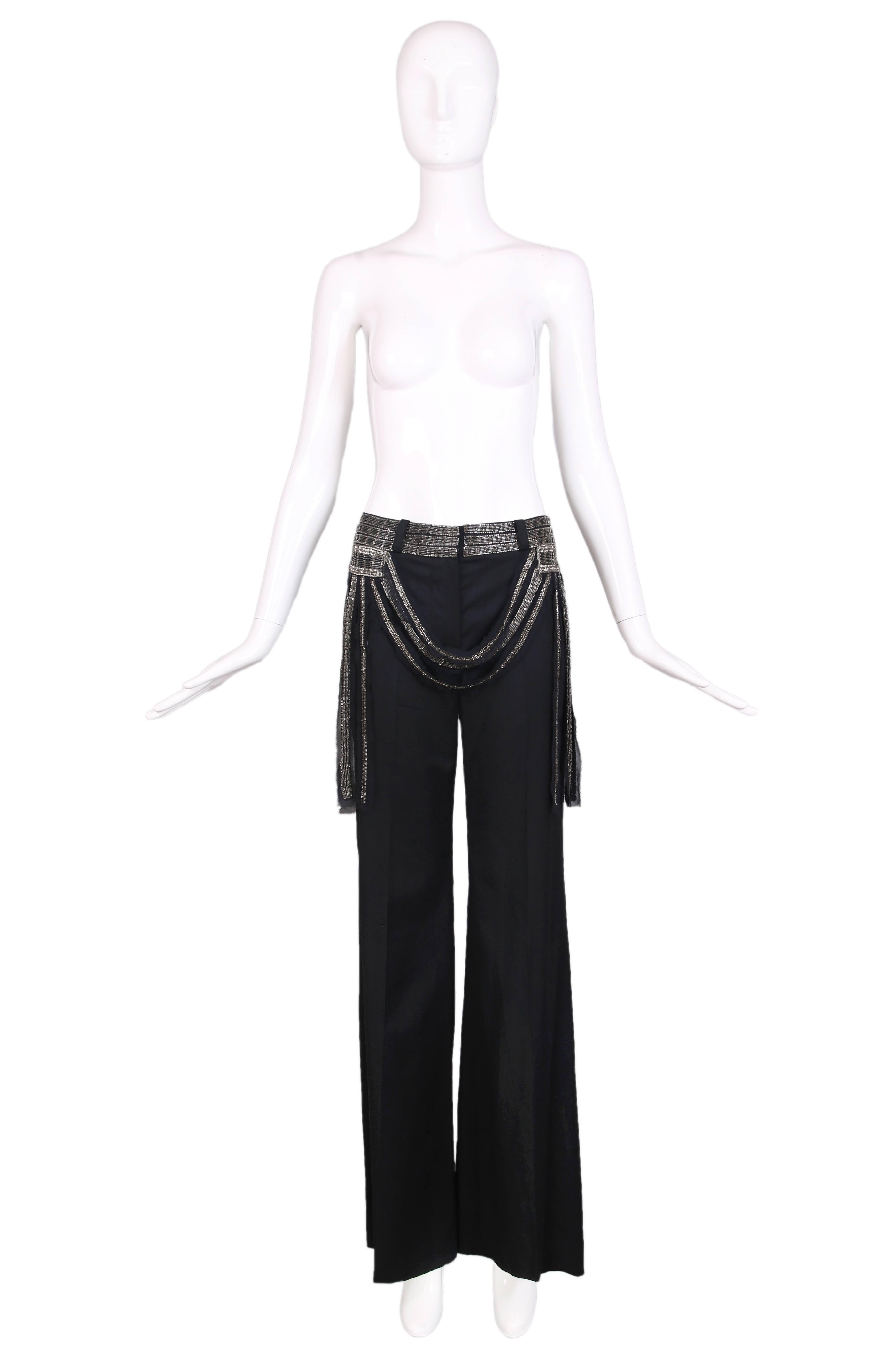 2002 Chloe by Stella McCartney black slightly flared trouser pants featuring a silver bugle bead-encrusted waistband. In excellent condition. Size EU 36.
MEASUREMENTS:
Waist - 30