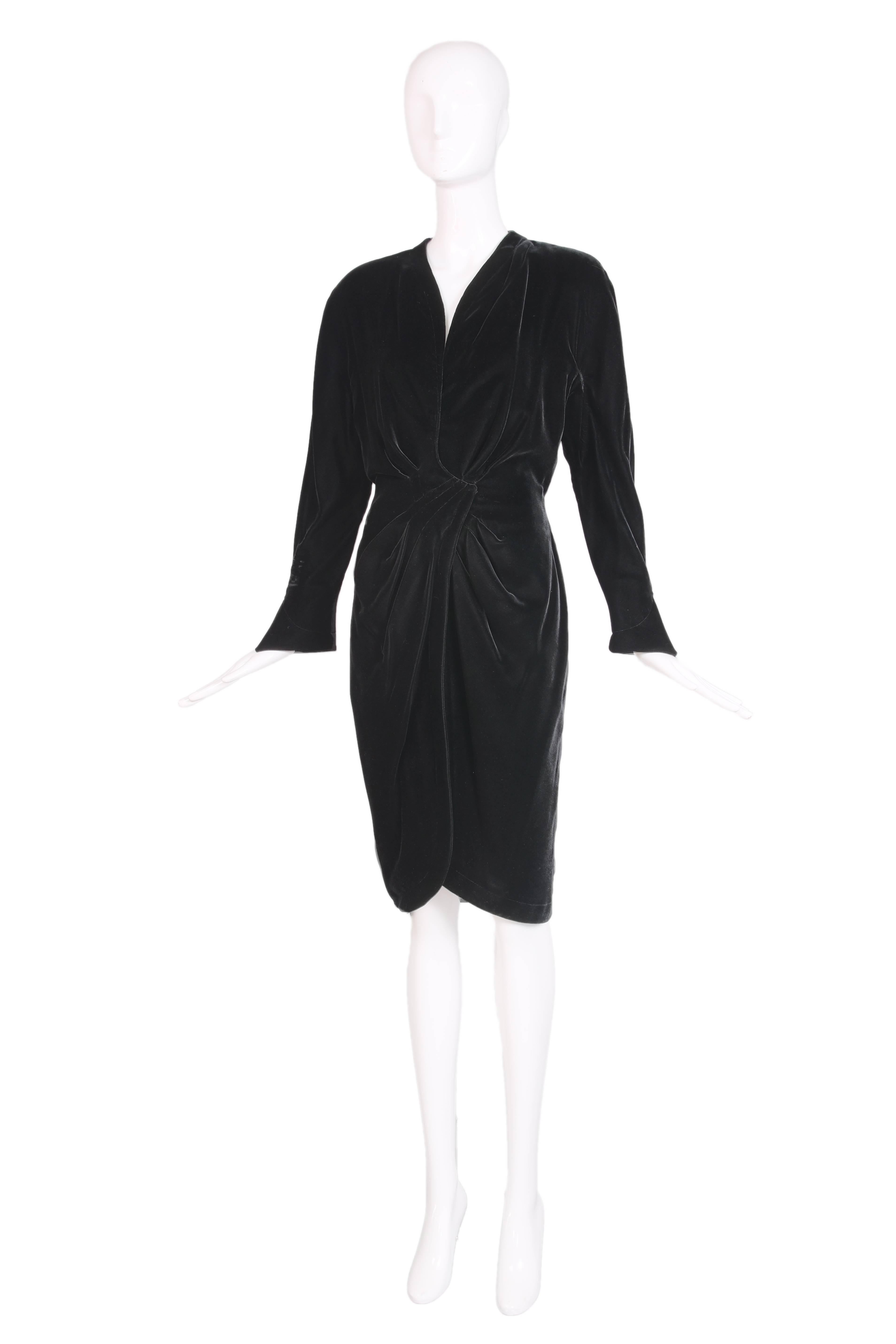 1990's Thierry Mugler black velvet wrap dress with hook and eye closure. Soft ruched detailing at the waist and hip that emphasizes Mugler's classic hourglass shape. Slight flare at the sleeves with a slit. In excellent condition with about an inch