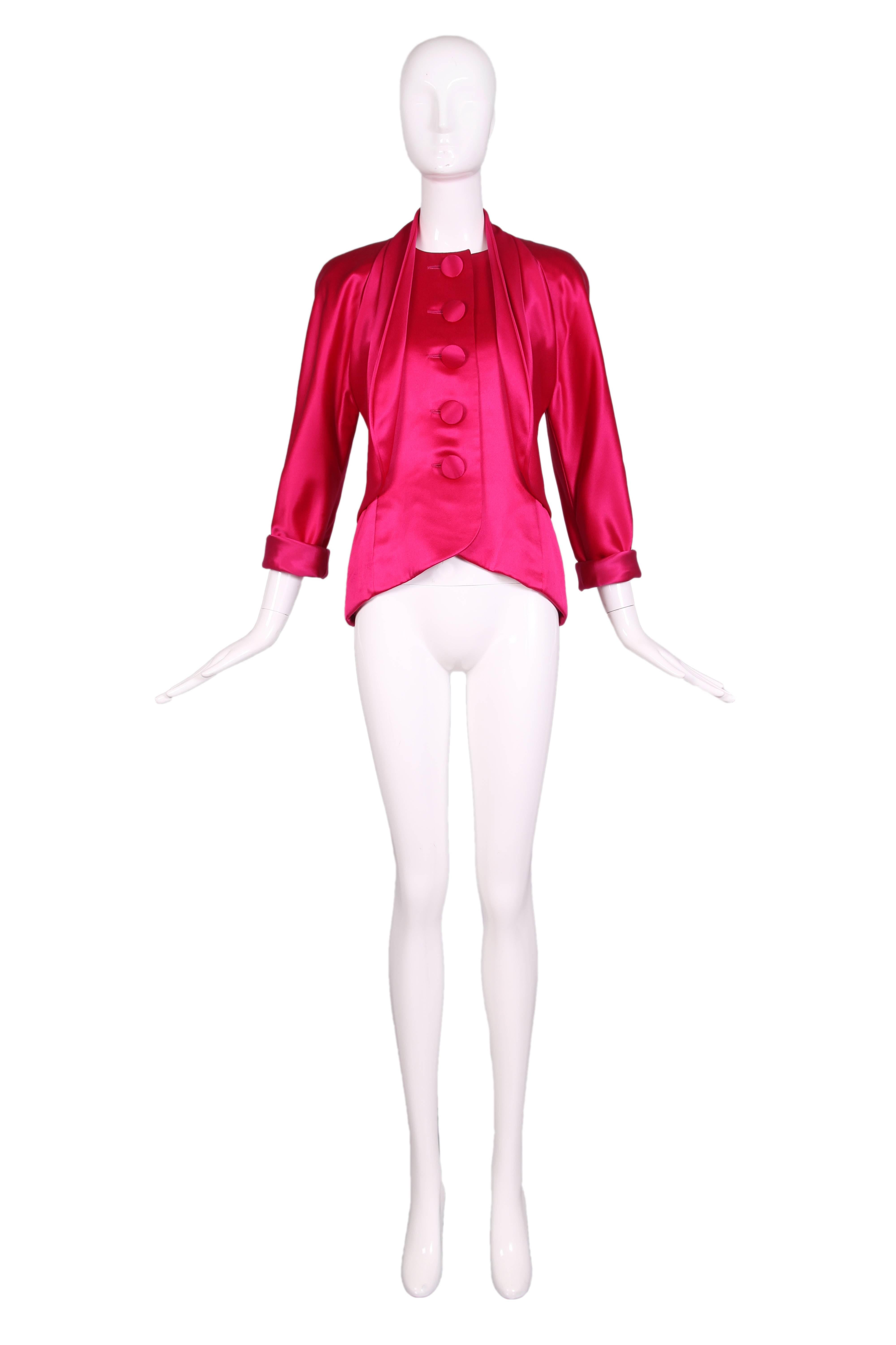 Vintage Galanos hot pink satin jacket blouse with subtle tulip hem, over-sized fabric buttons down the front and cuff sleeves.  In excellent condition with tiny scattered pulls and abrasions which is the nature of this fabric.
MEASUREMENTS (in