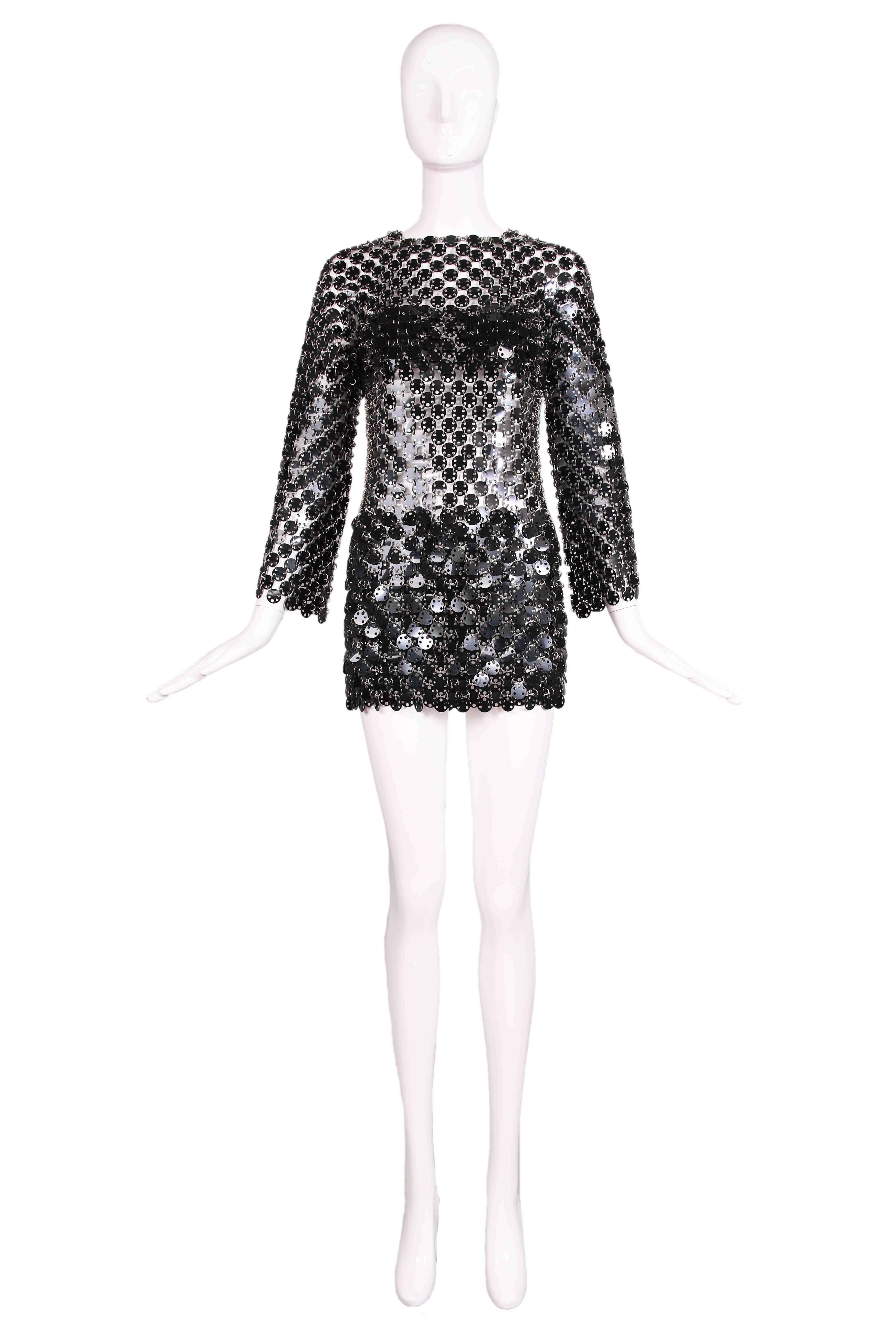 1969 Paco Rabanne black chain mini dress assembled from linked black rhodoid discs with a heavier cluster of discs at bust and hip. This is an iconic and rare museum piece. In excellent condition. Would fit a US 2-4.
MEASUREMENTS:
Bust - 36